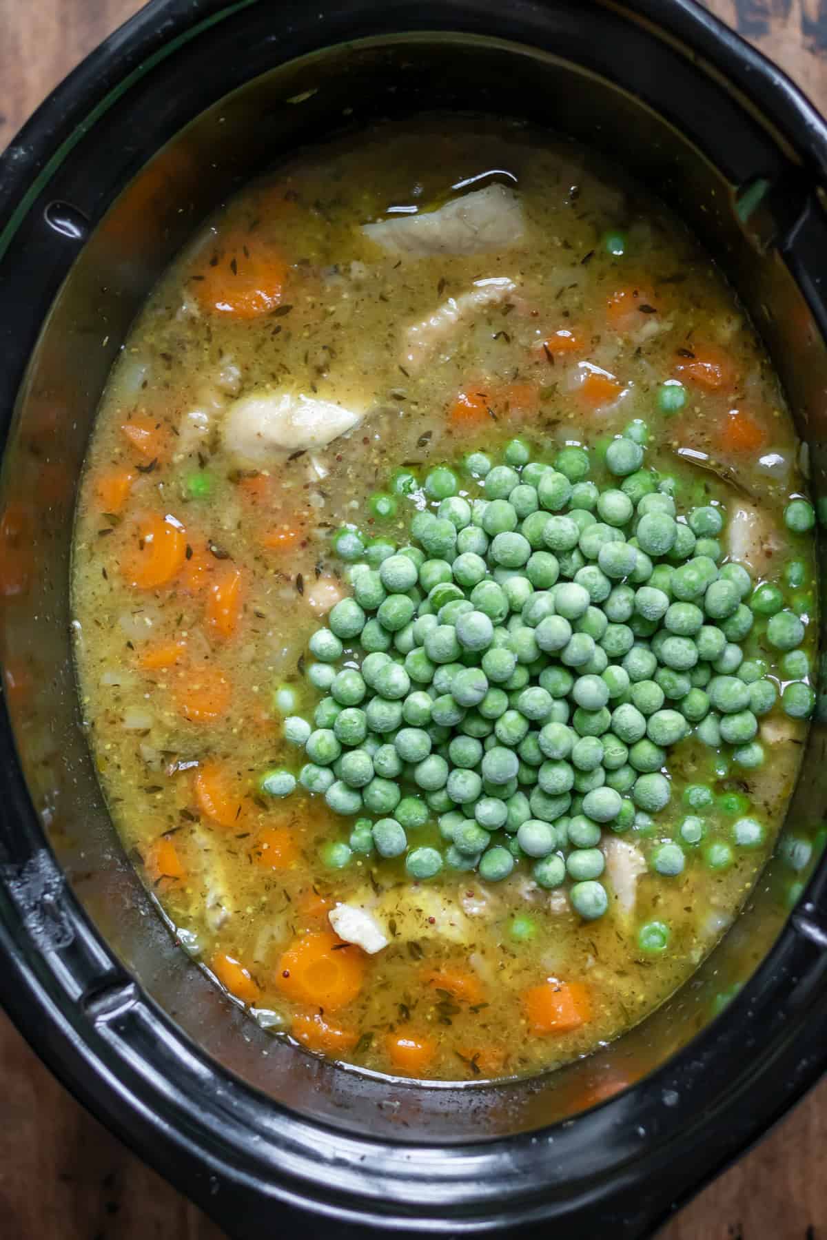 Frozen peas added to the slow cooker.