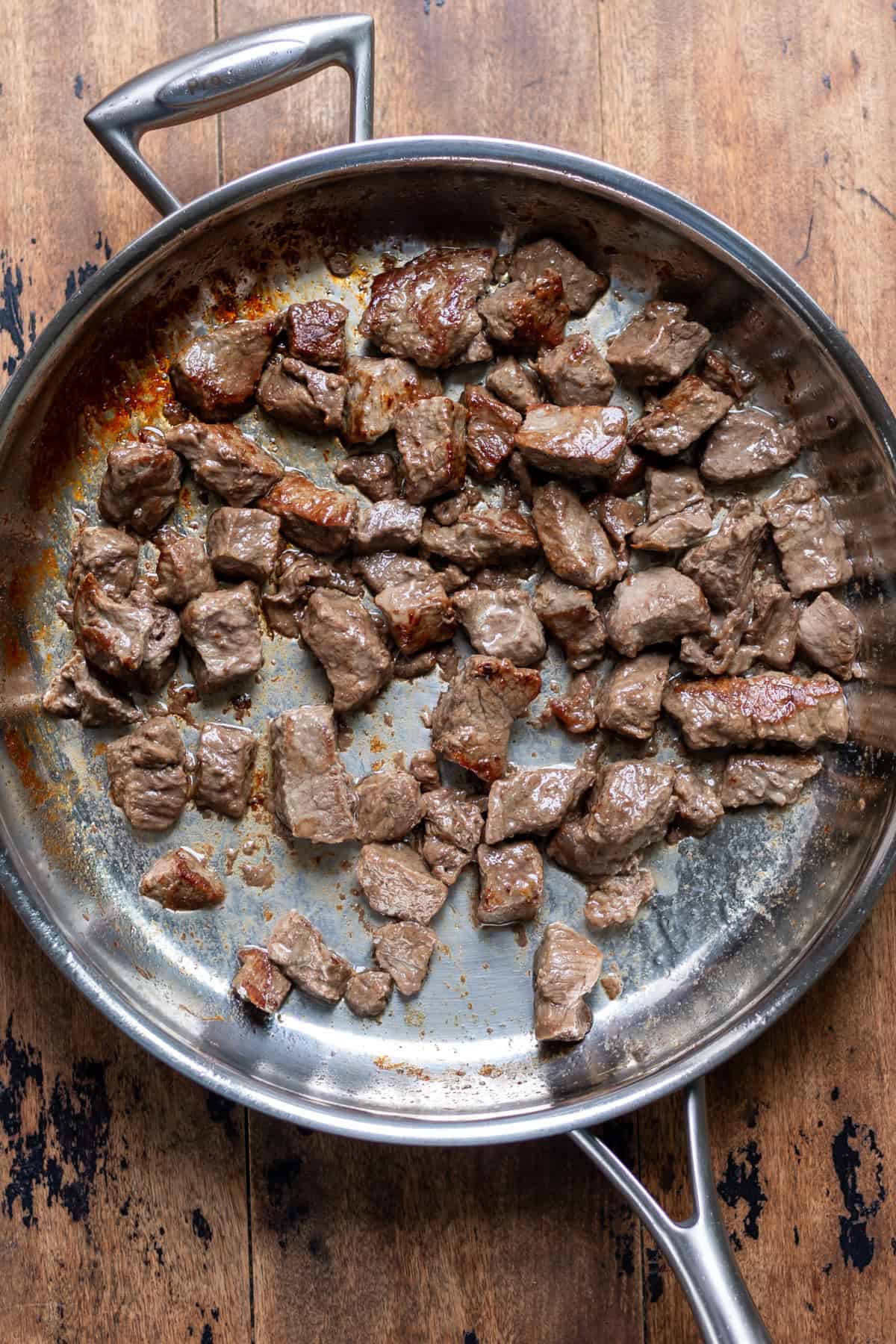 Browning the beef in a skillet.