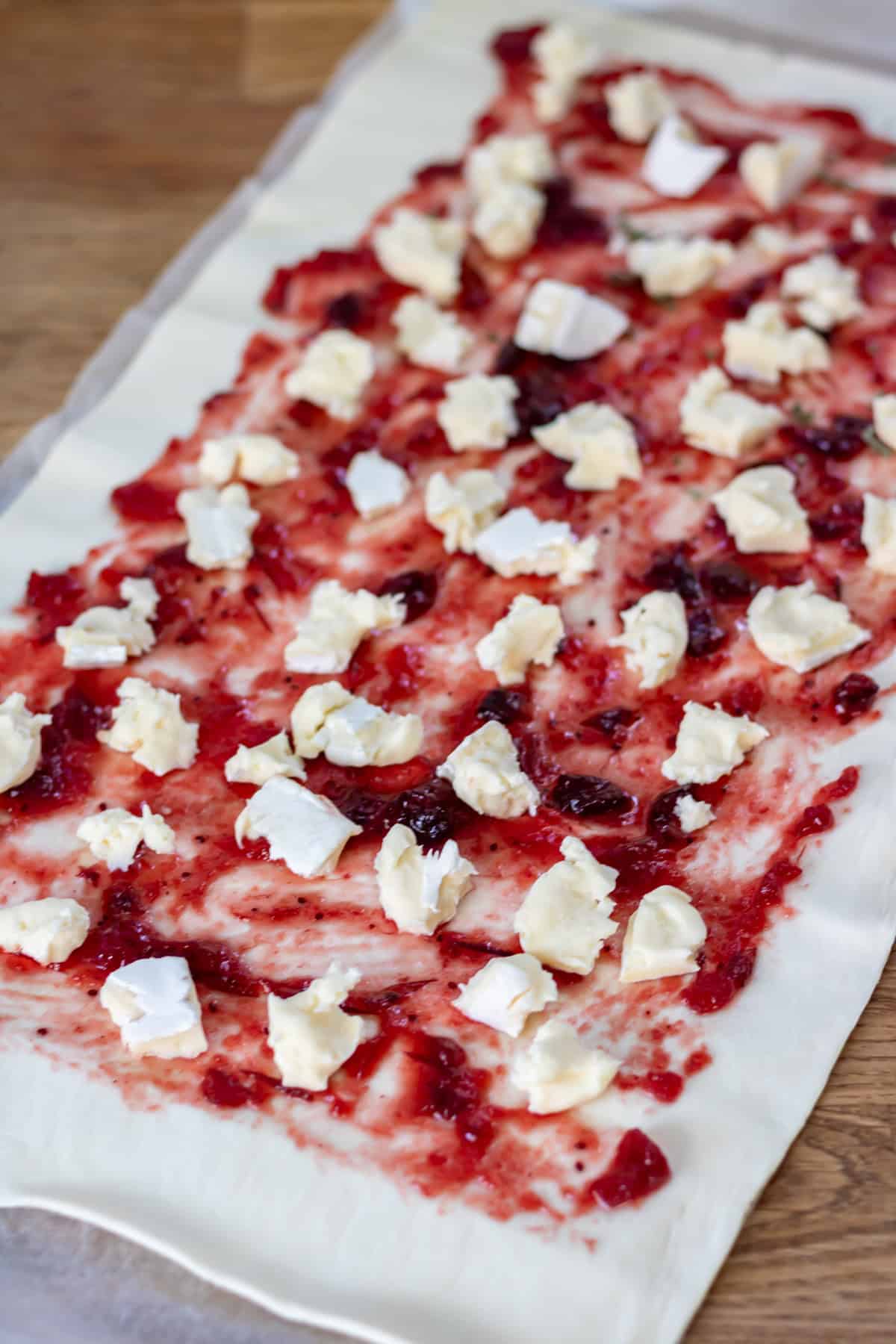 Adding chunks of brie.