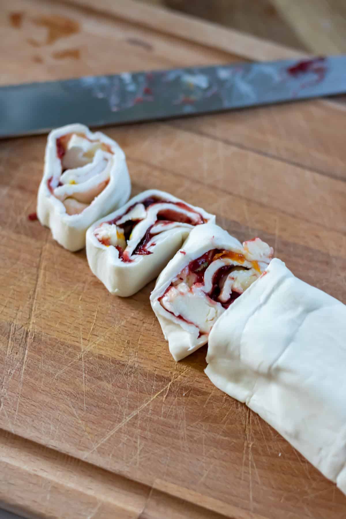 Slicing the pinwheels from the pastry log.