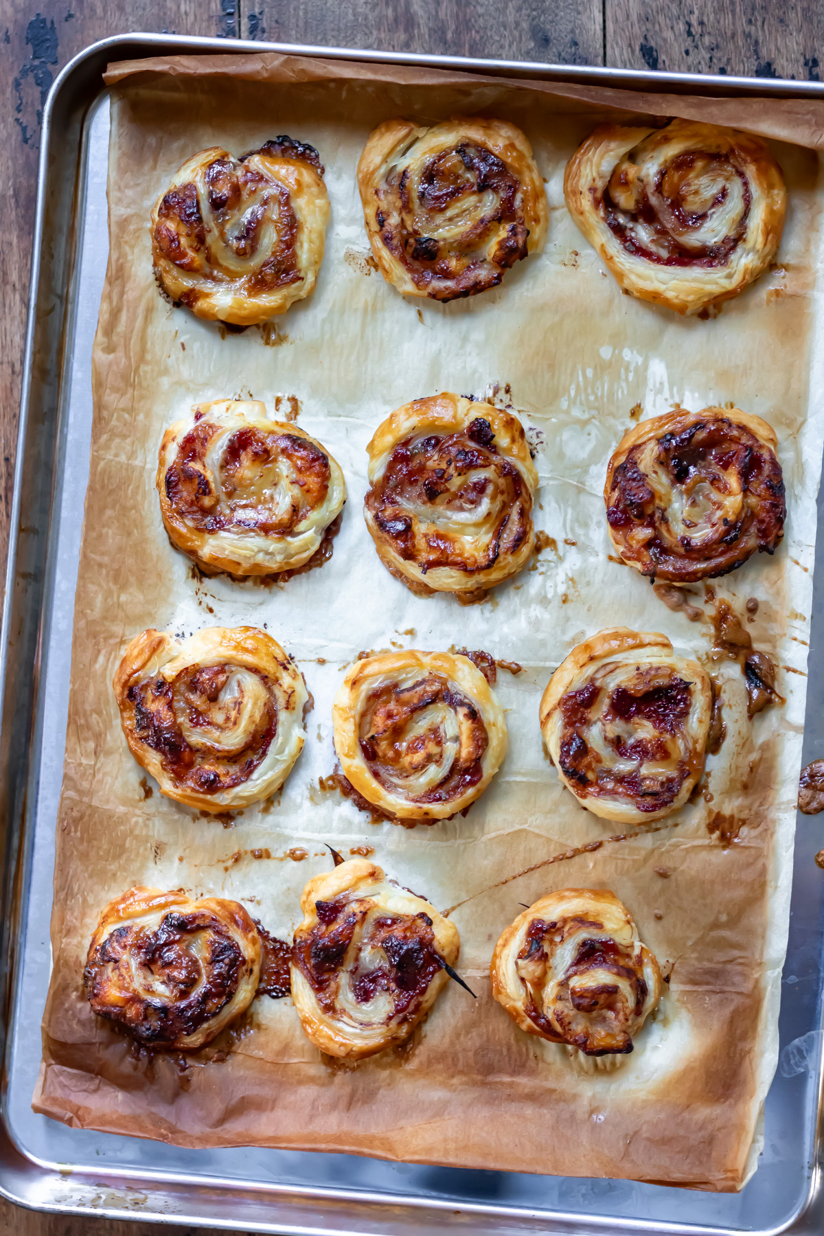 A baking sheet of baked cranberry brie pinwheels.