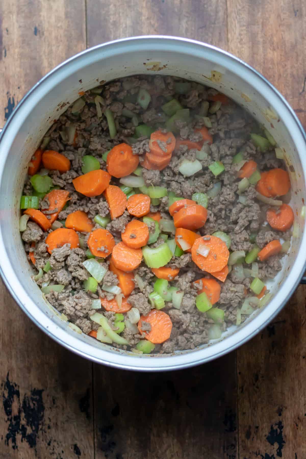 Cooking the carrots, onion and celery in the beef.