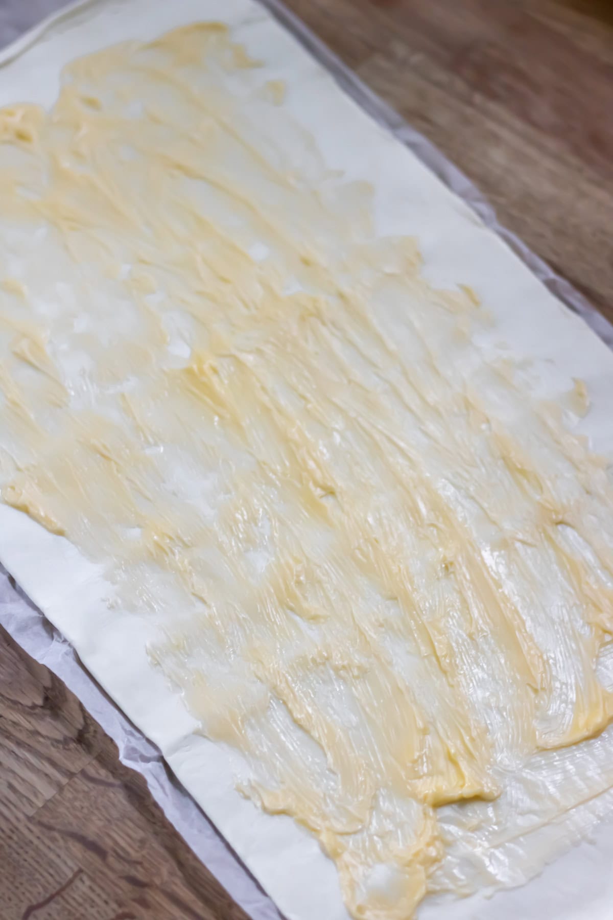 Butter spread onto the puff pastry.