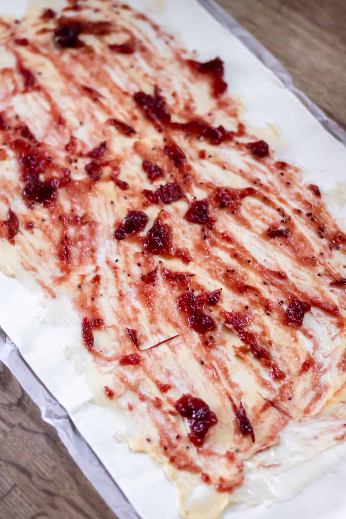 Cranberry sauce spread onto the pastry.
