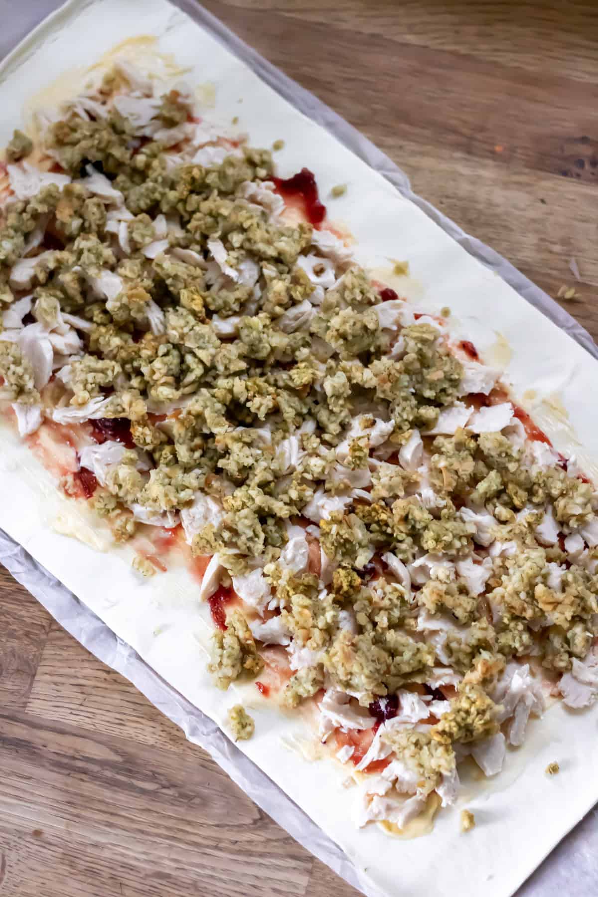 Leftover stuffing sprinkled onto the pastry.