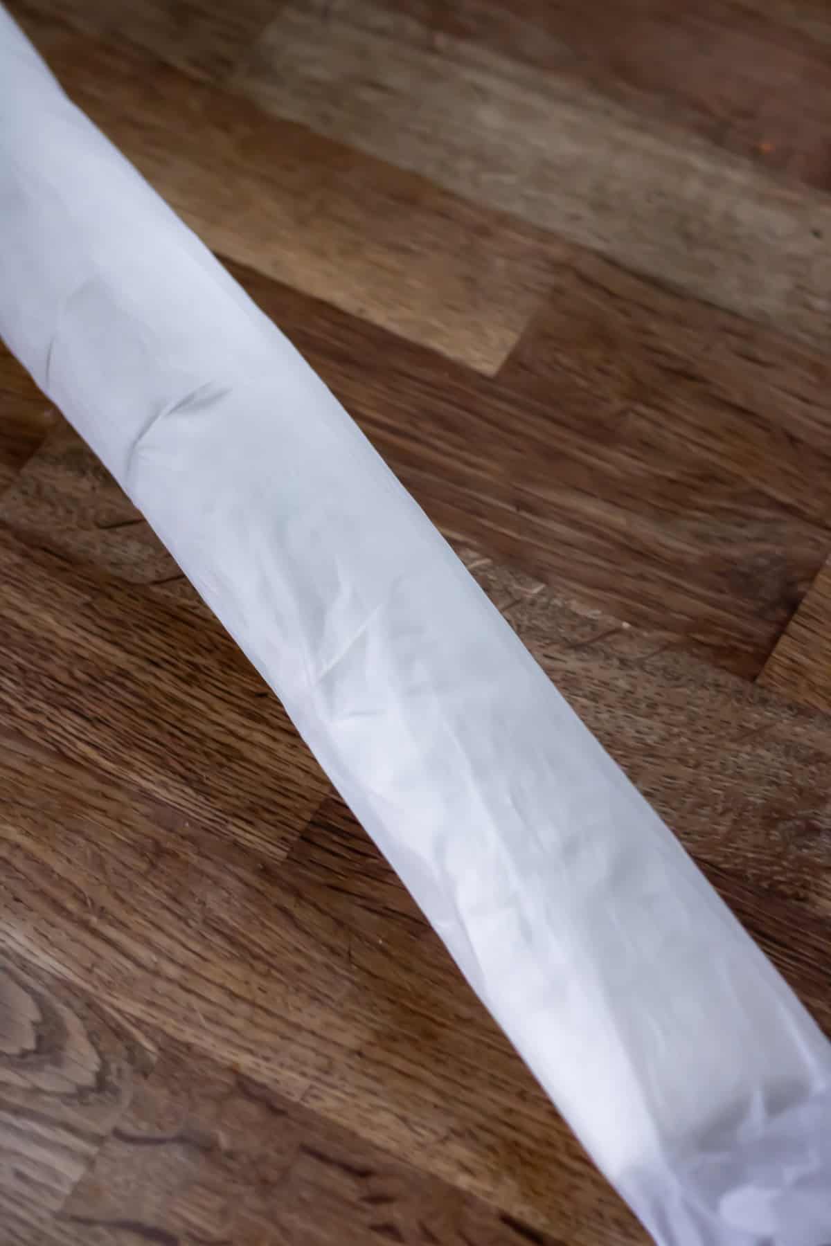 Puff pastry rolled along the long side and wrapped in baking paper.