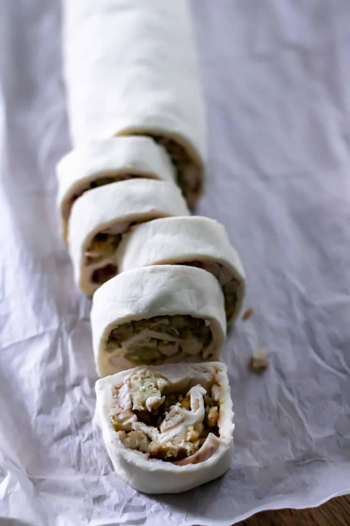 Slicing the chilled leftover turkey pinwheels.