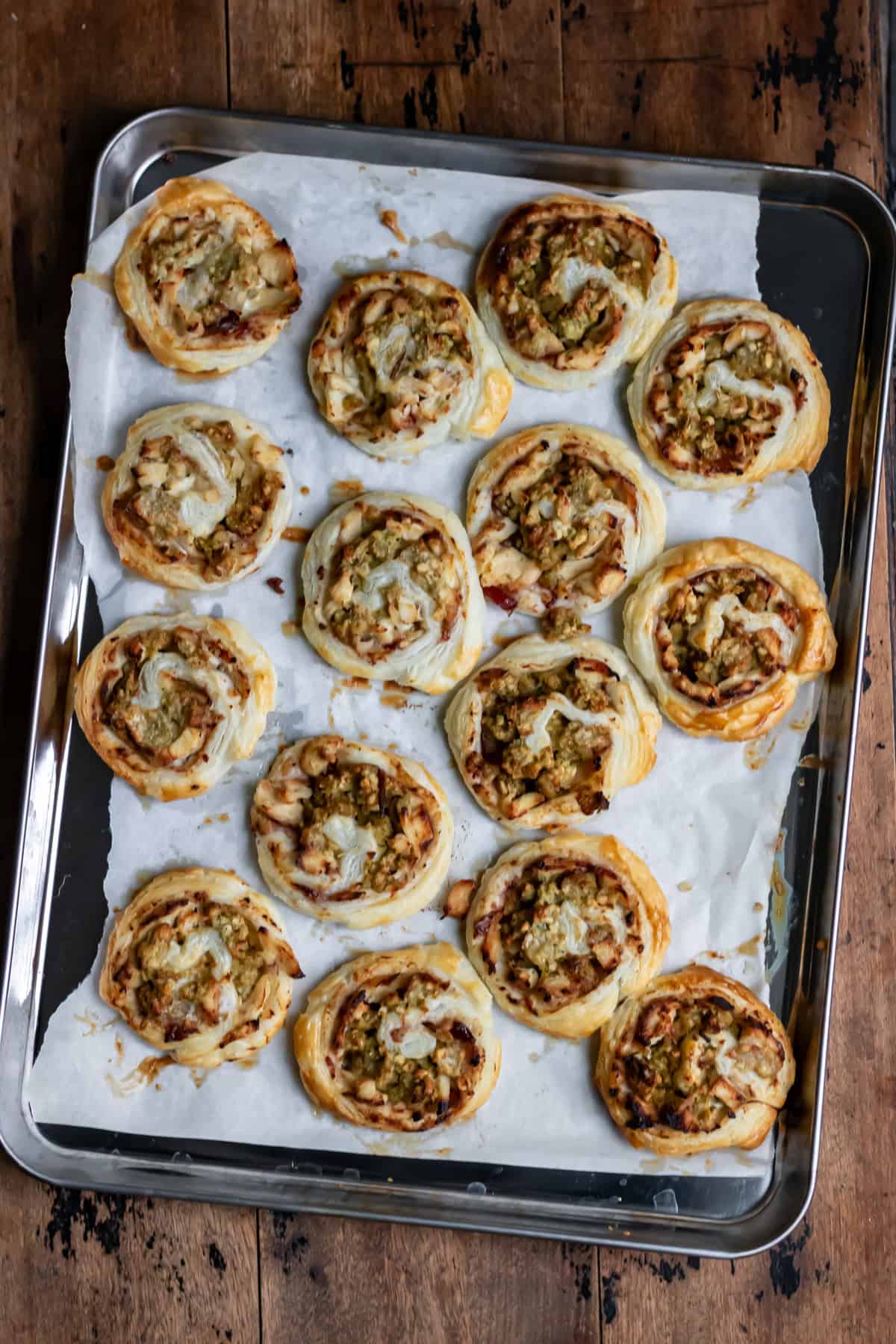 Baked leftover turkey stuffing pinwheels on a baking sheet.