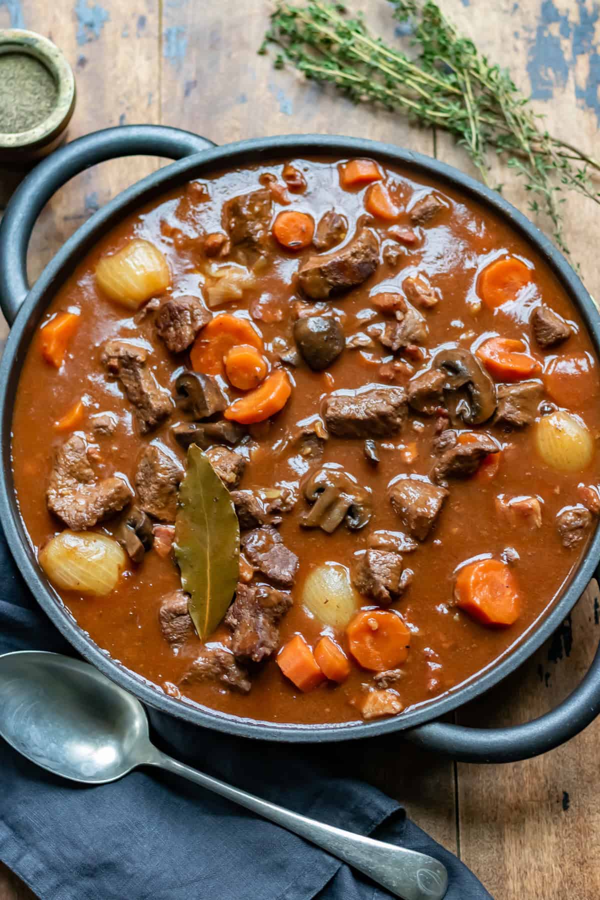 Serving dish of beef bourguignon on a table.