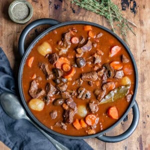 Serving dish of beef bourguignon on a table.
