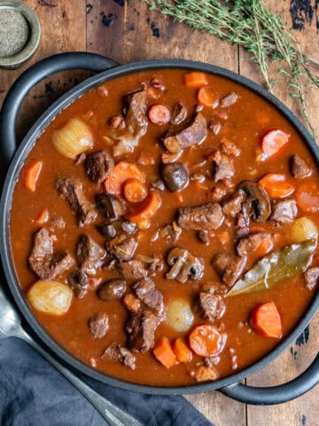 Serving dish of beef bourguignon on a table.