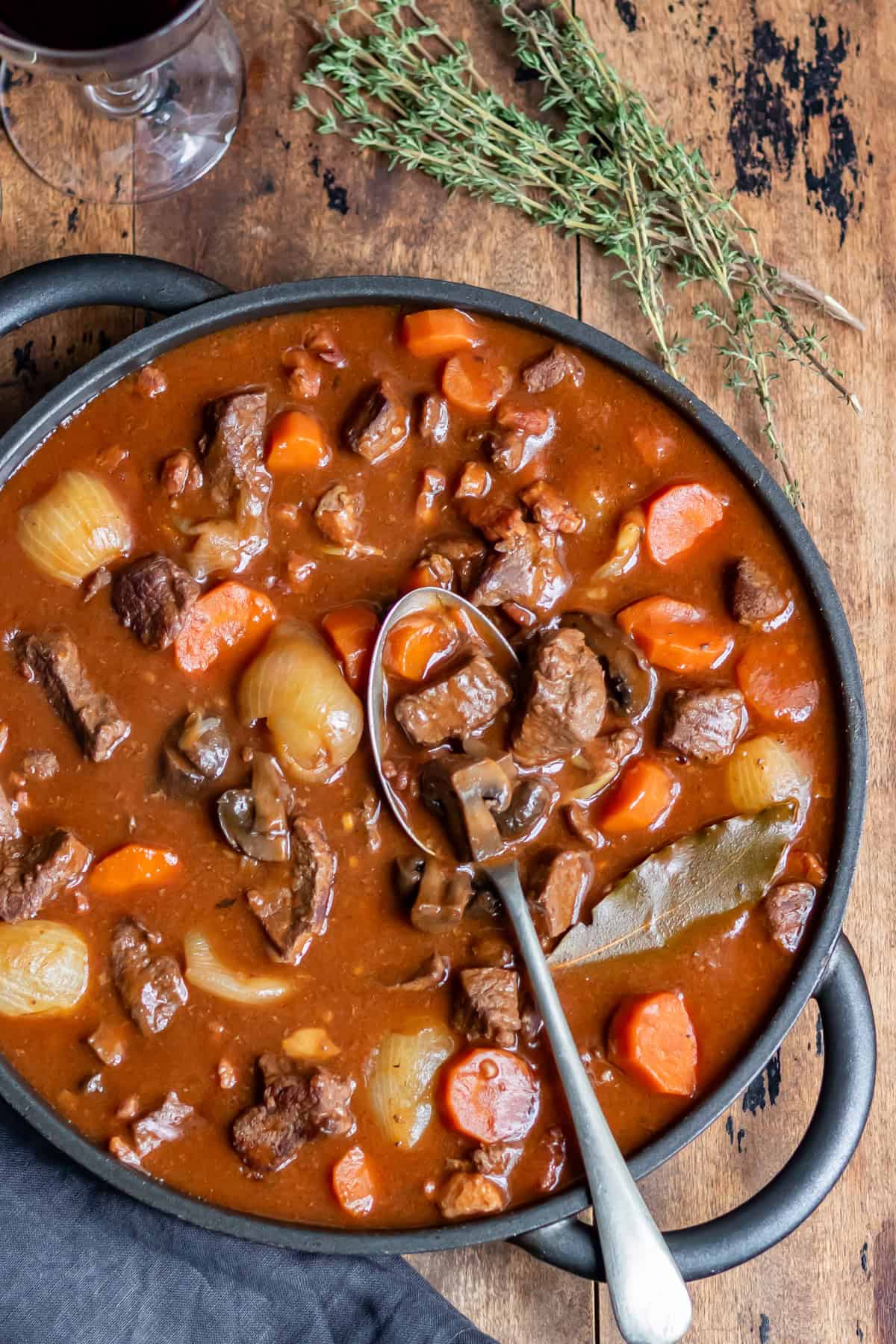 Spoon in a dish of slow cooker beouf bourguignon.