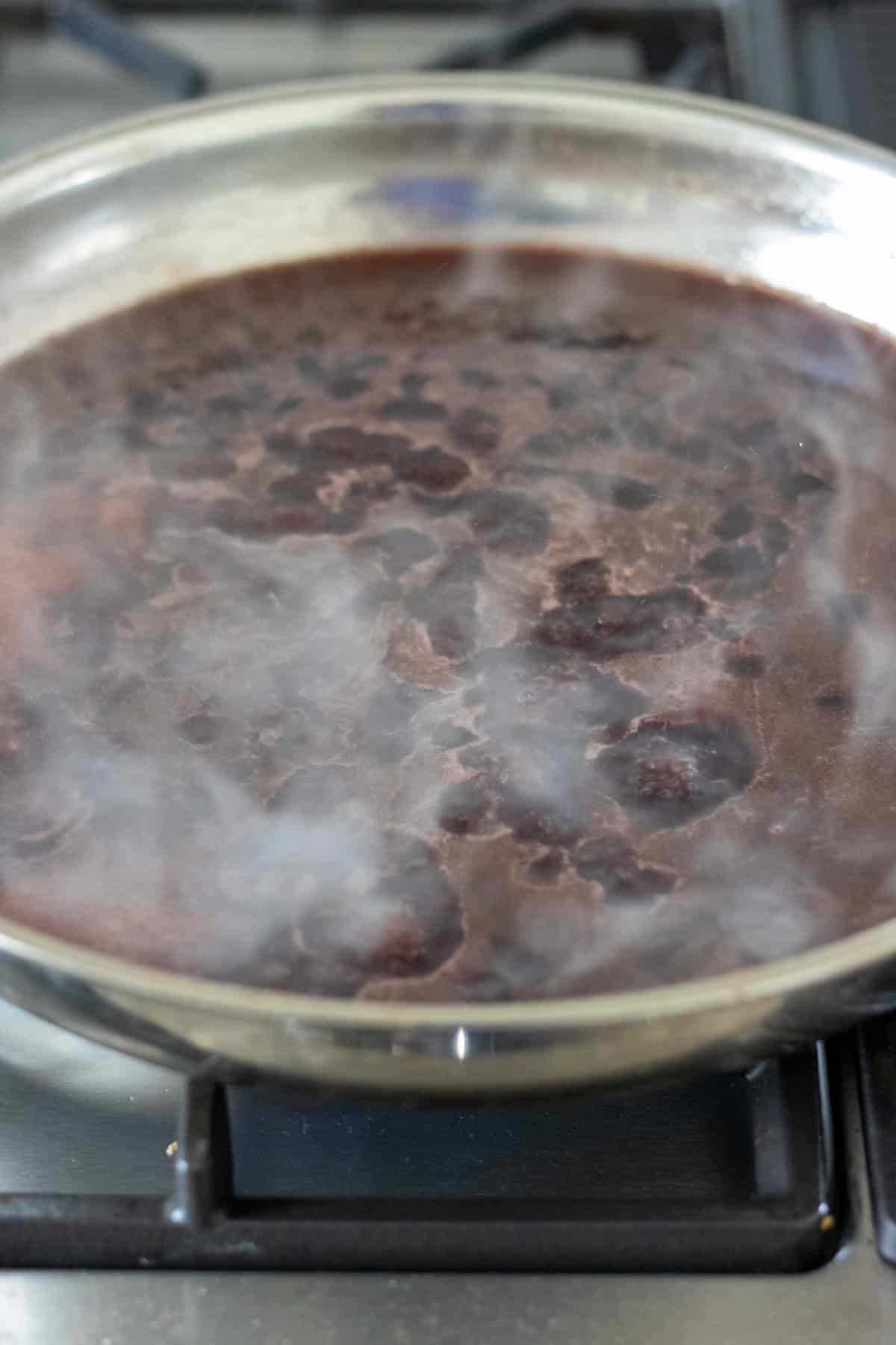 Red wine simmering in the pan.