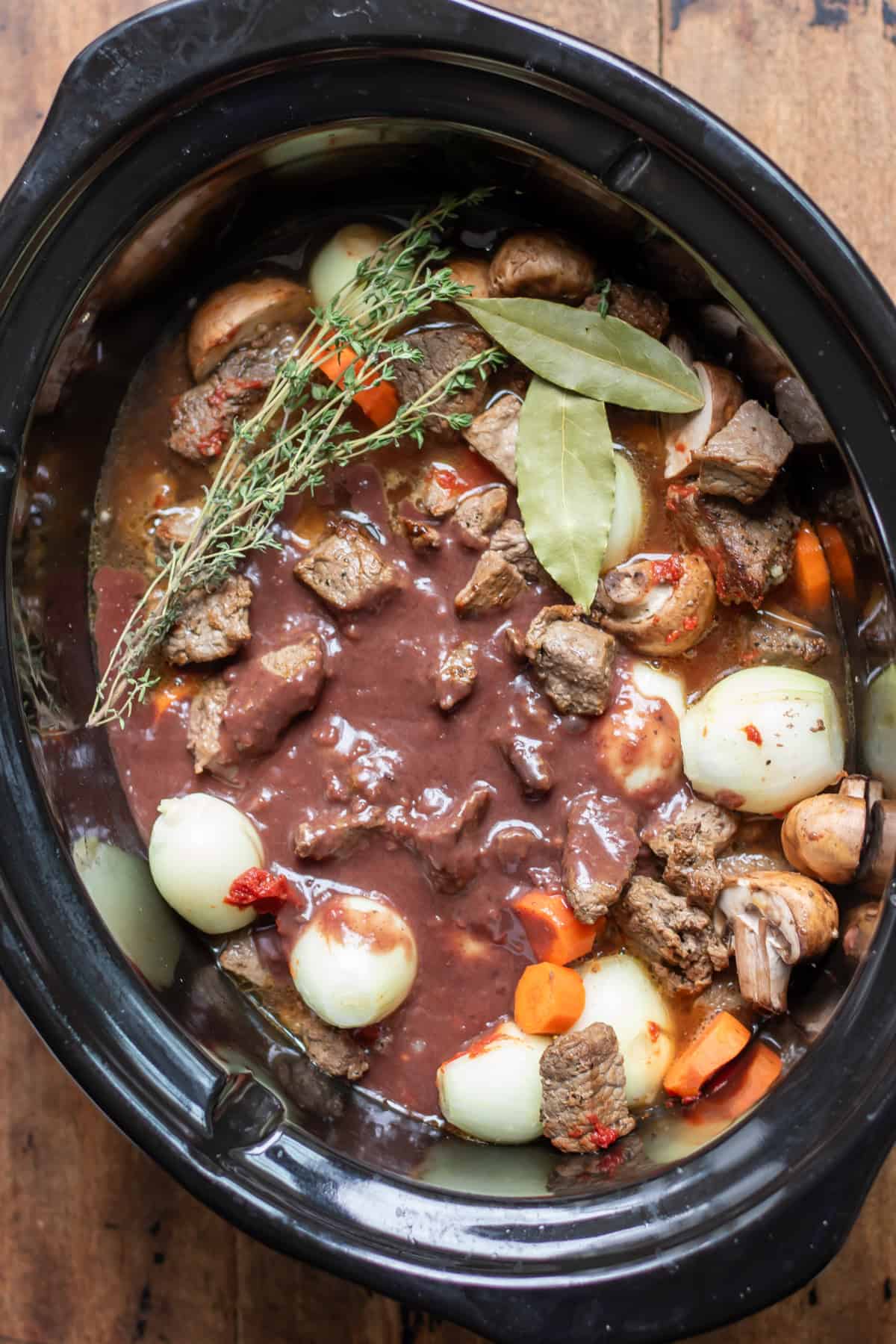 Wine reduction added to the slow cooker along with the beef and vegetables.