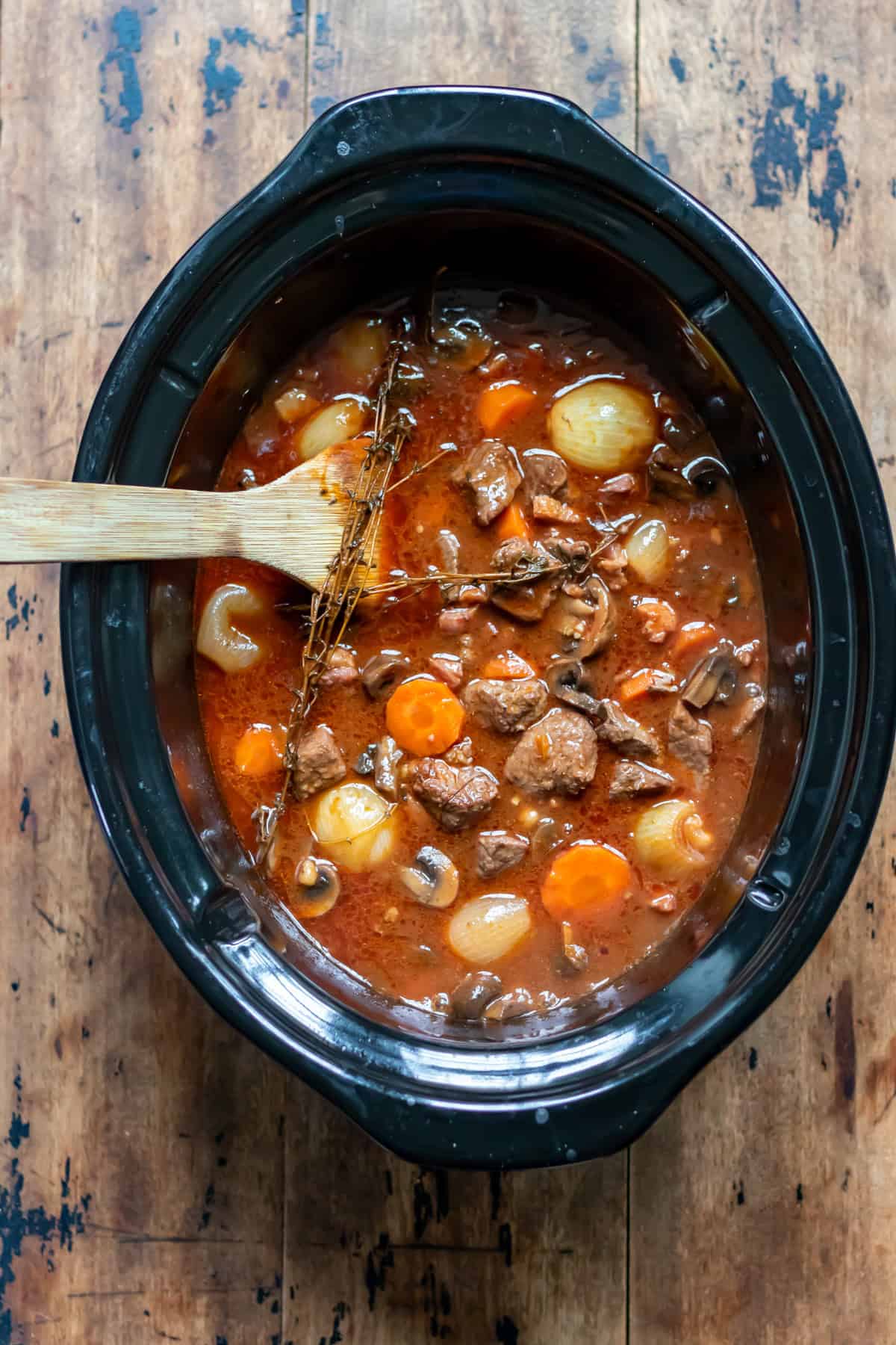 Cooked Beef Bourguignon in a crock pot.