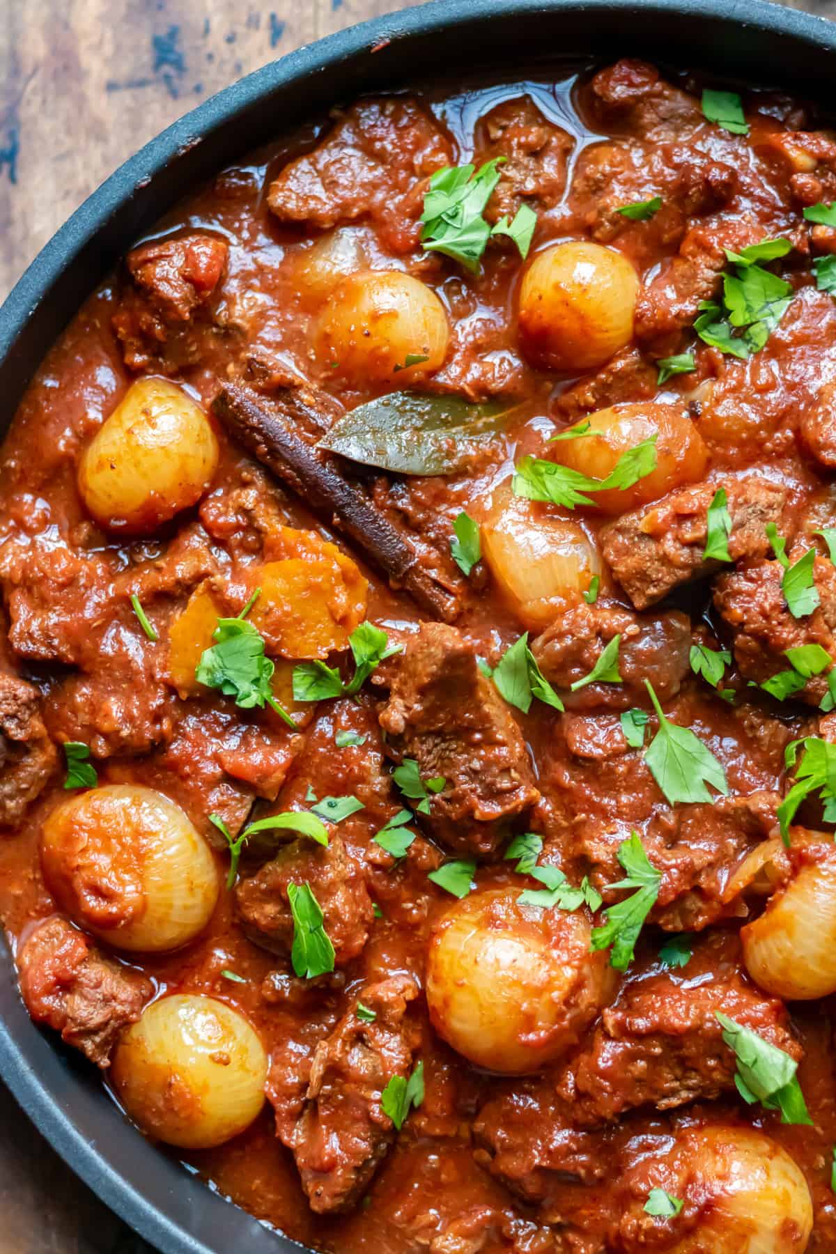 Close up of a serving dish of slow cooker Greek stifado beef stew.