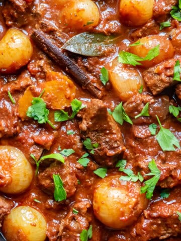 Close up of a serving dish of slow cooker Greek stifado beef stew.