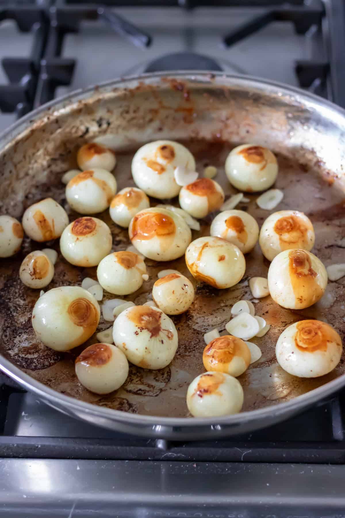 Pan frying pearl onions.