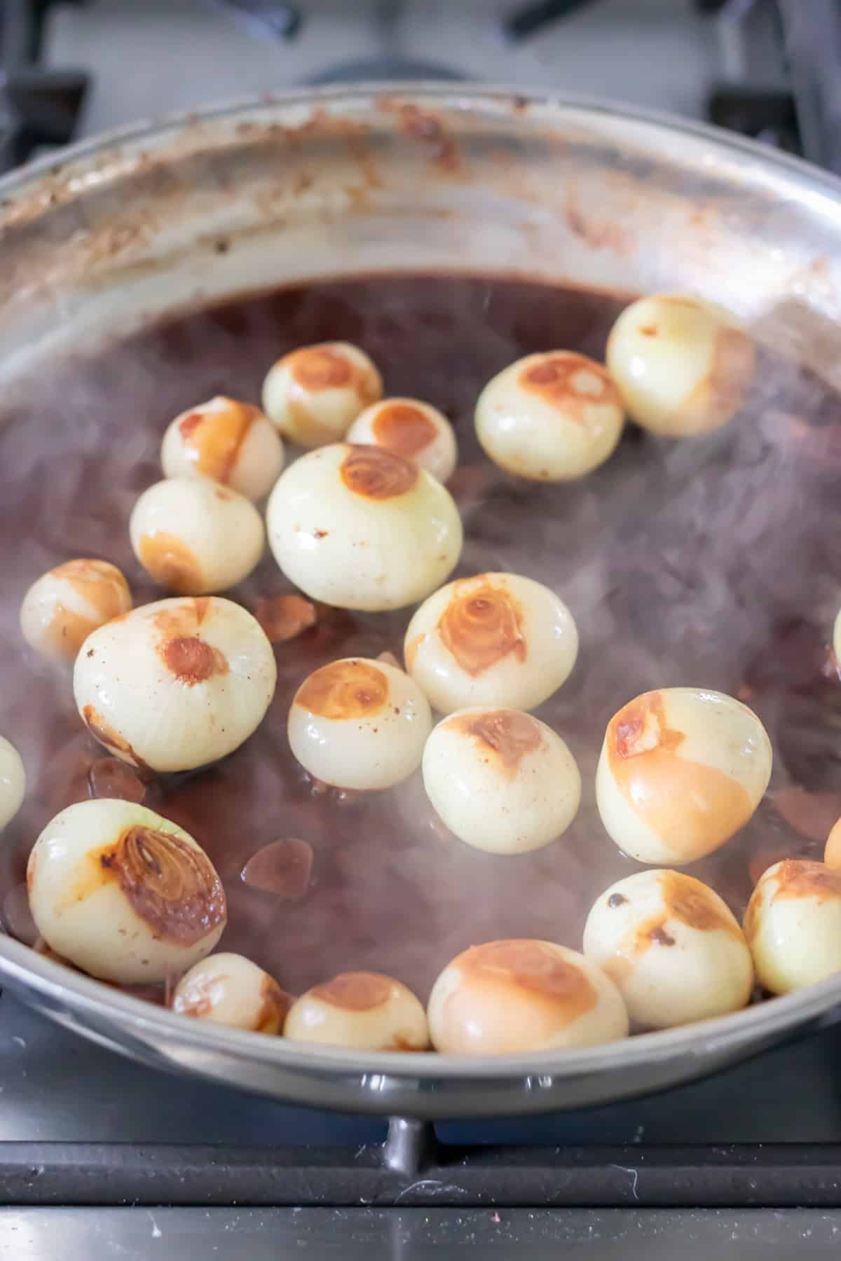 Red wine and garlic added to the onions.