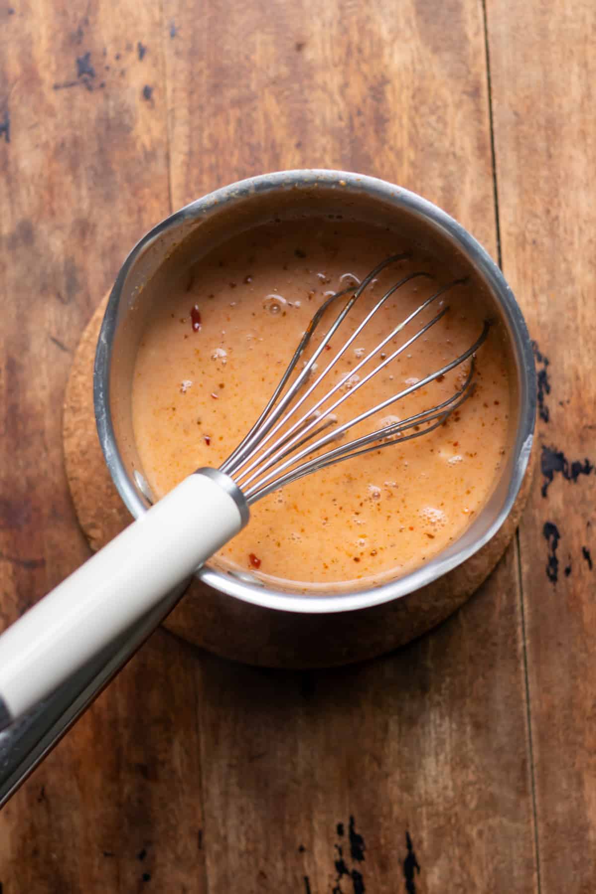 Coconut milk whisked into the stock.