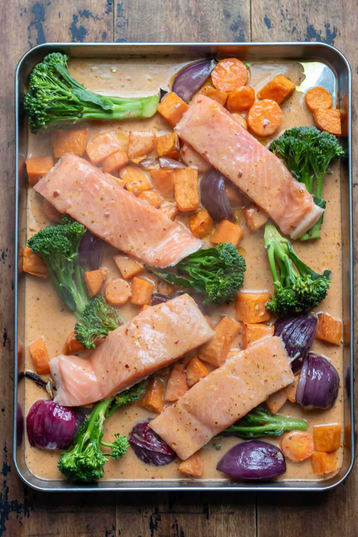 Thai red curry sauce poured over the salmon and veggies.