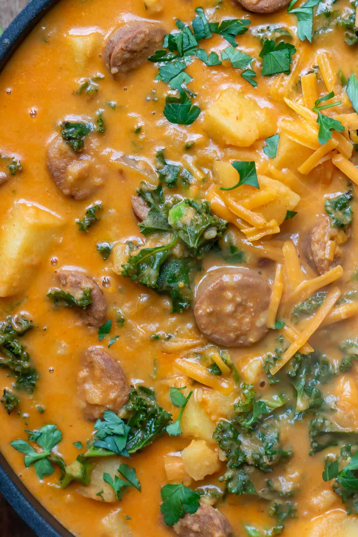 Close up of chorizo potato soup with kale.