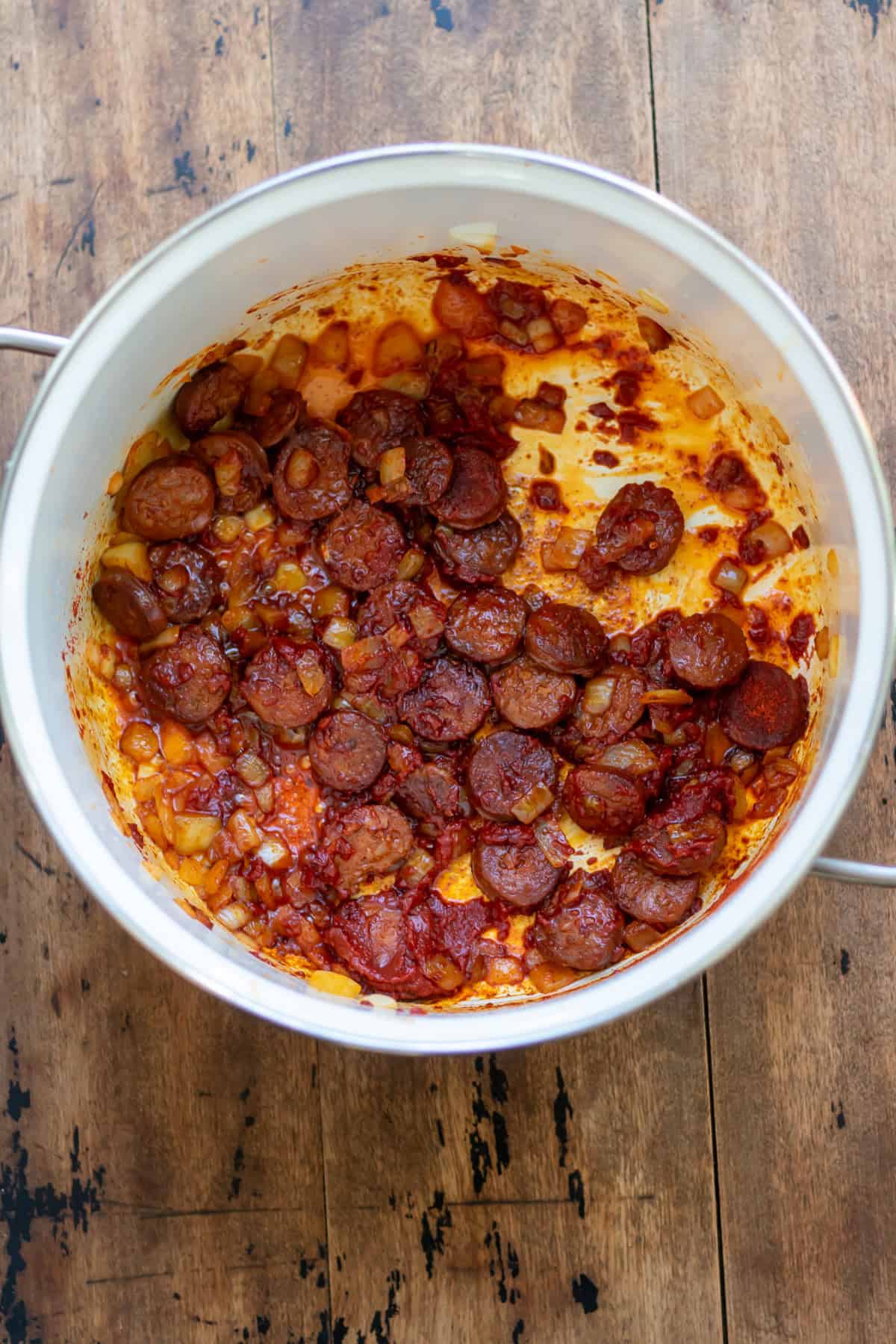 Spices and tomato paste added to the pot.