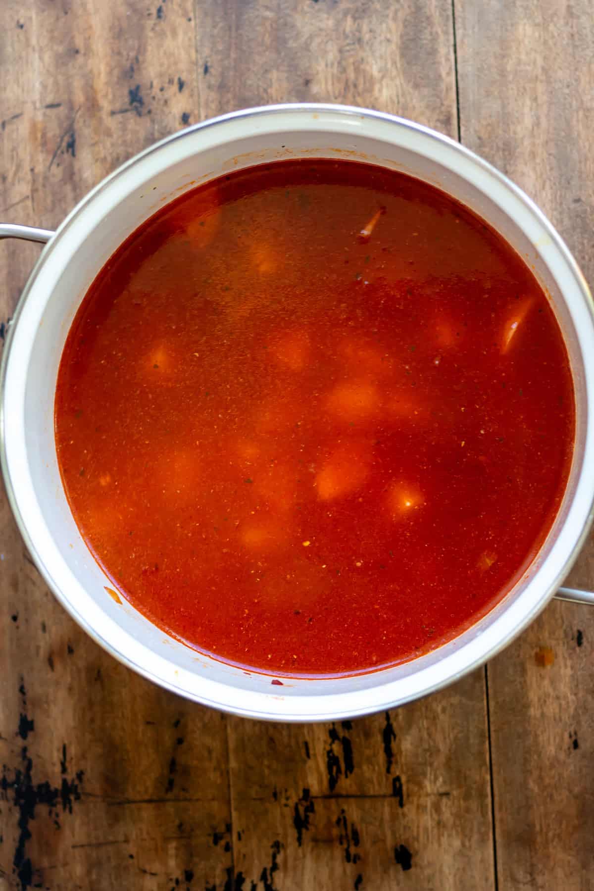Potatoes, stock and water added to the pot.