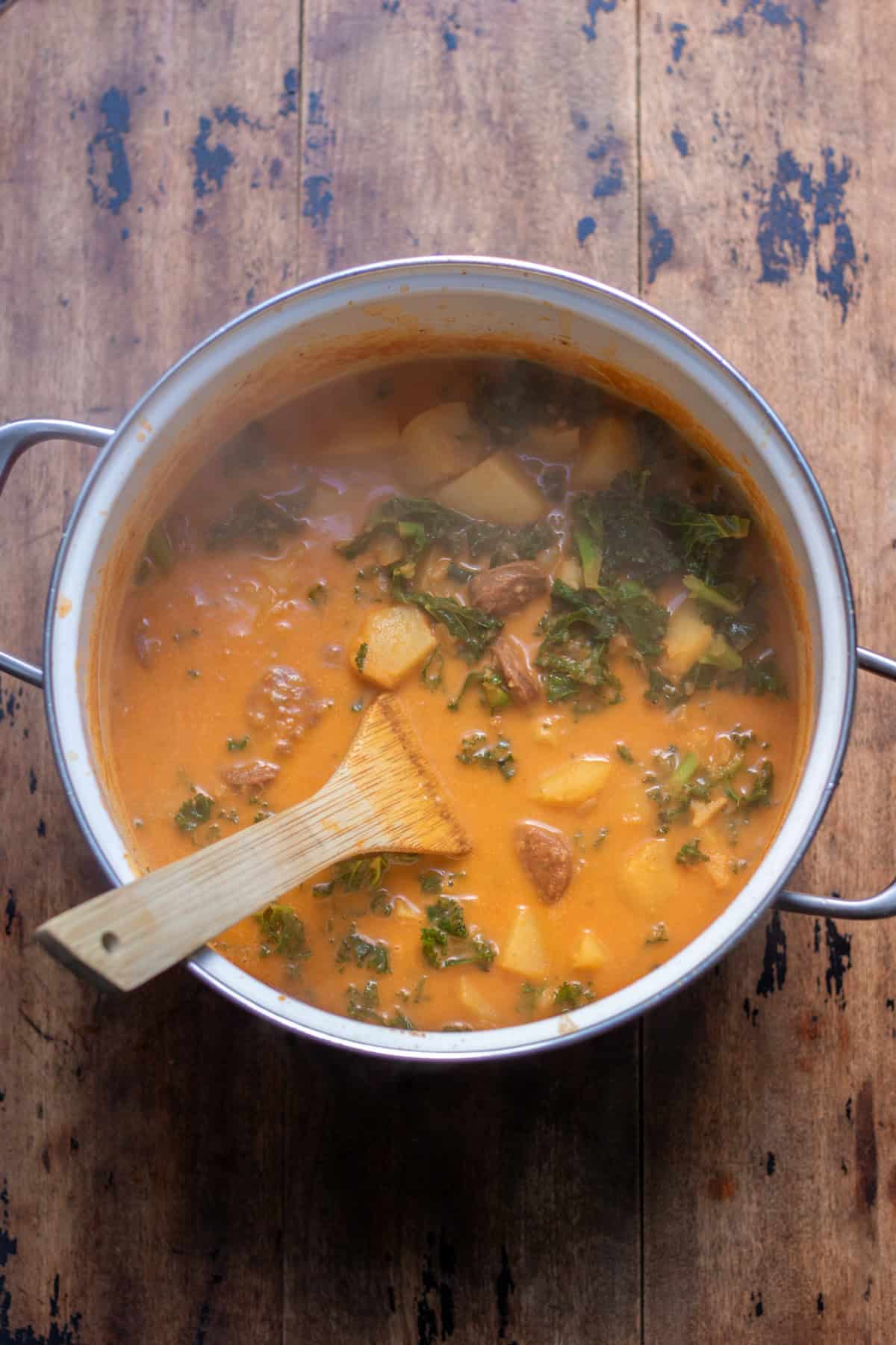 Cooked chorizo potato soup in the soup pot.