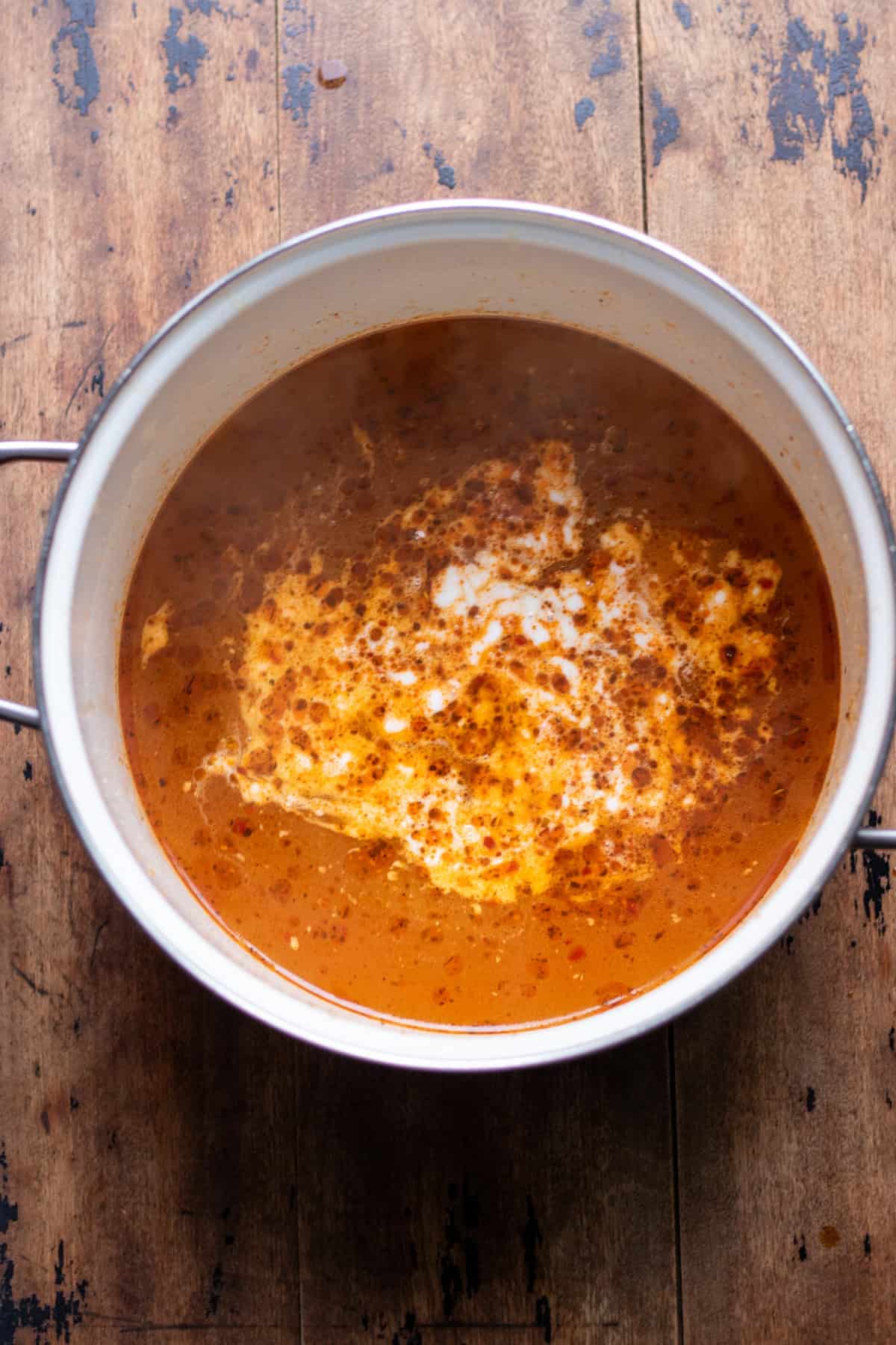 Stock and coconut added to the pot.