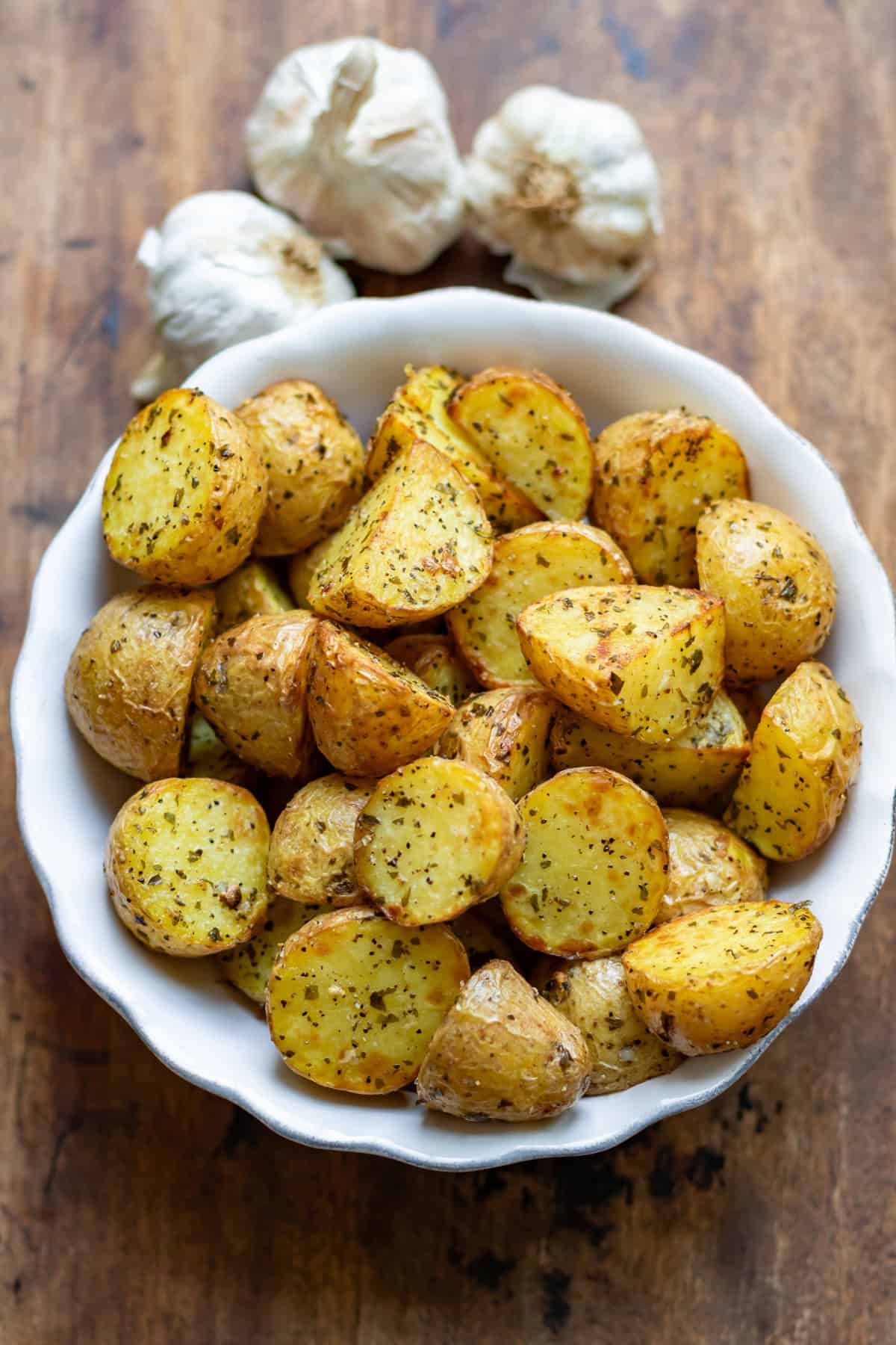 Close up of a serving dish of garlic baby potatoes.