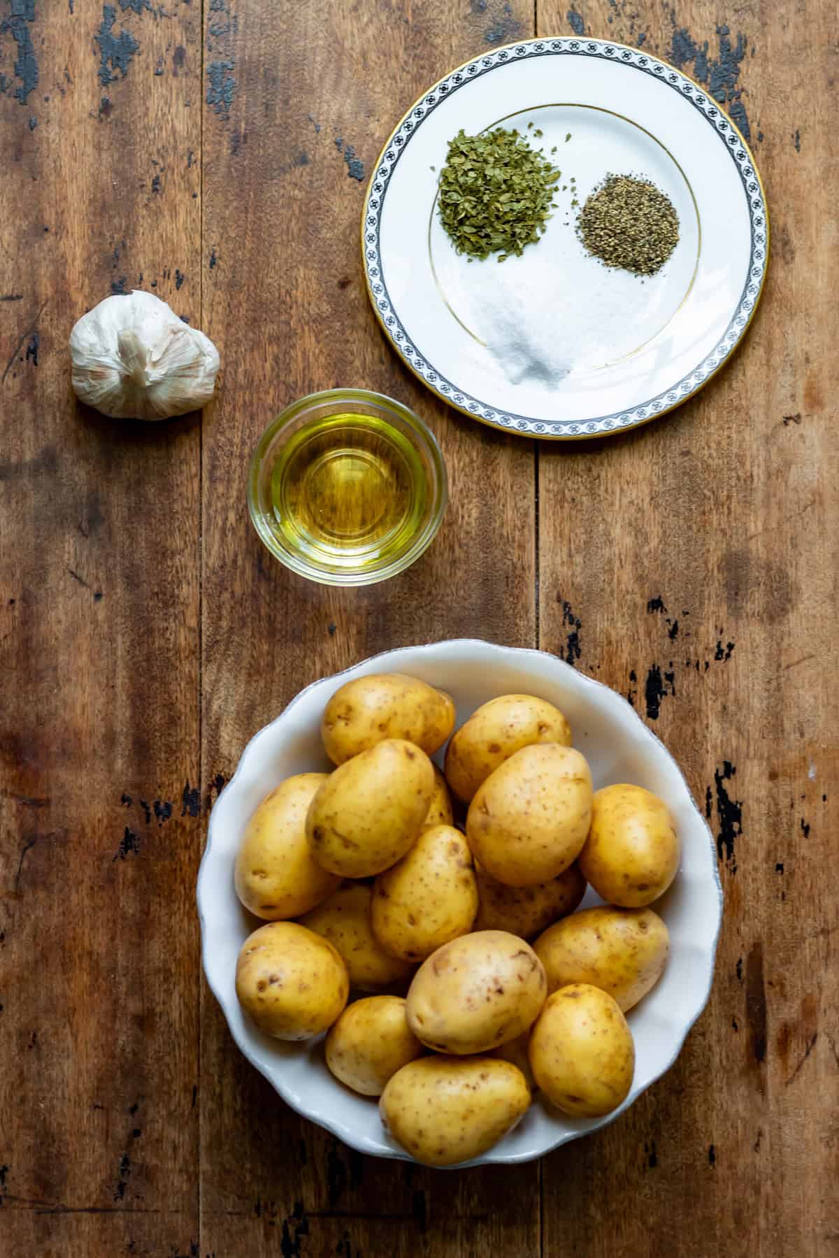 Ingredients for air fryer garlic baby potatoes on a table.