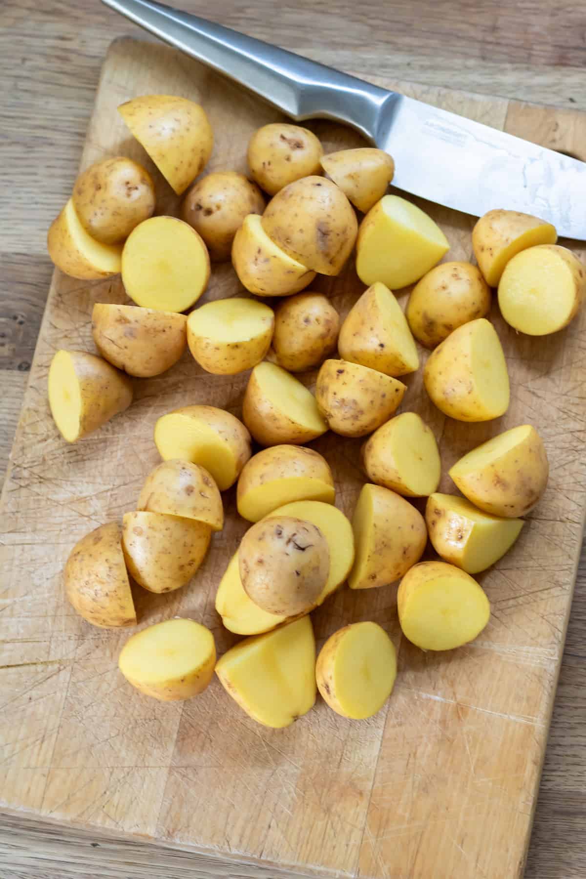 Halving baby potatoes.