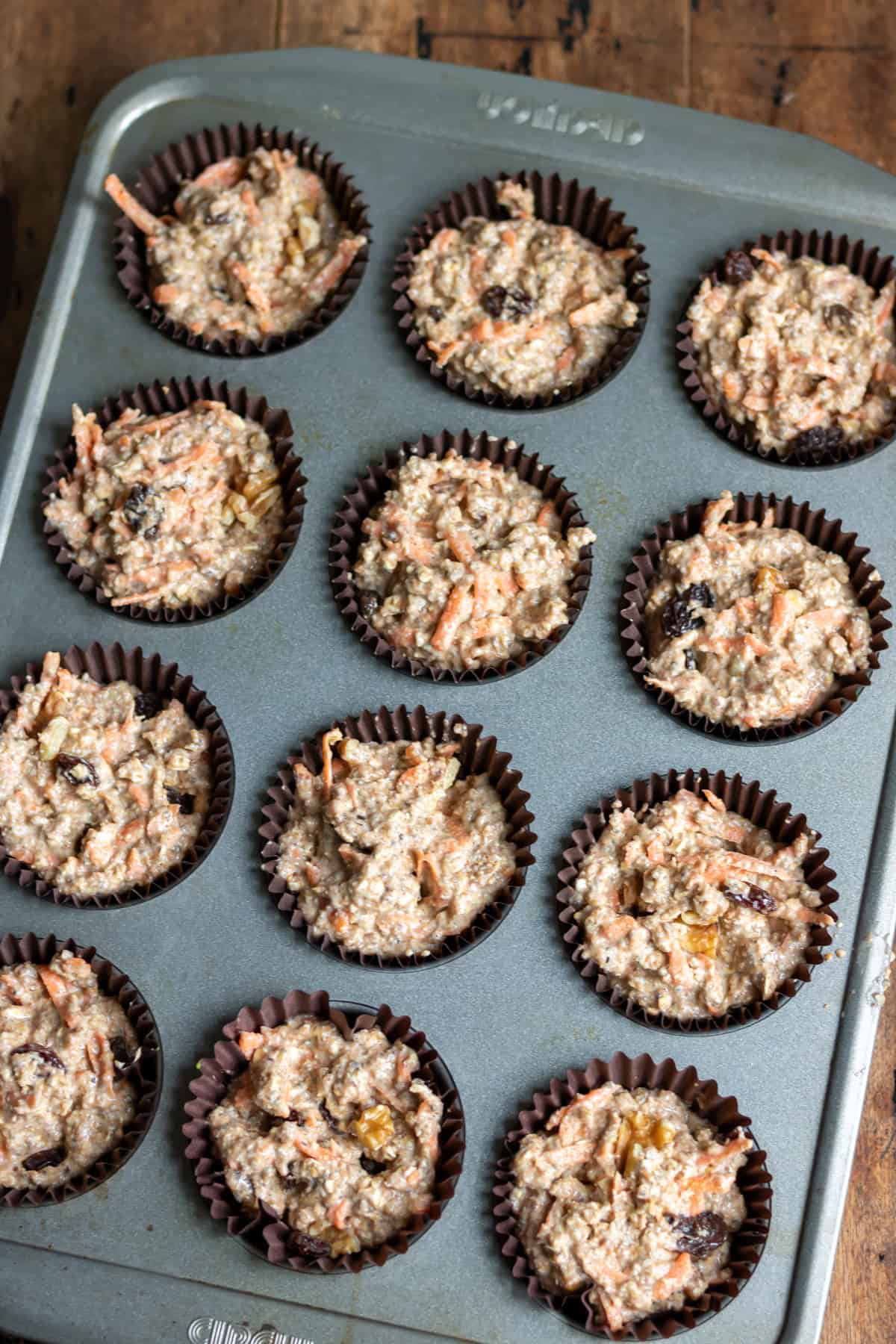 Muffin batter in the lined muffin pan.