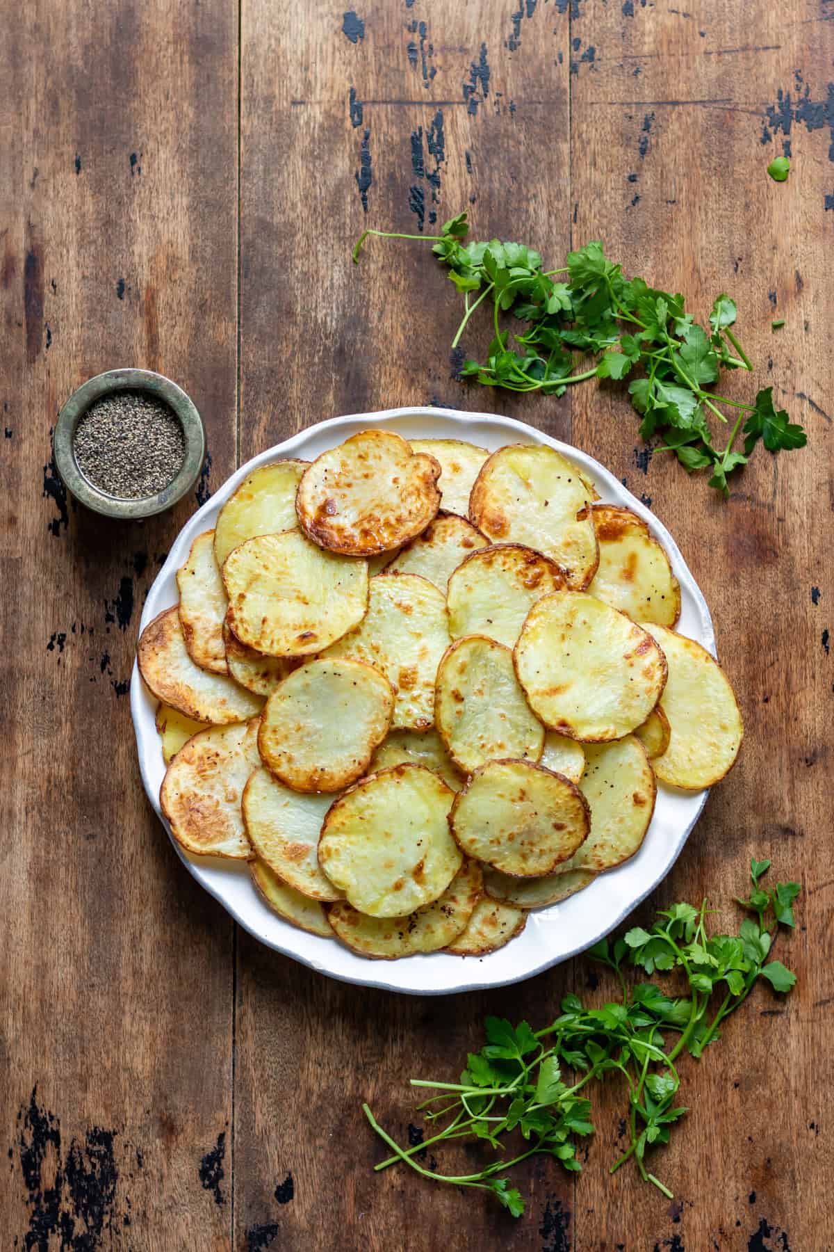 A plate of air fryer sliced potatoes.