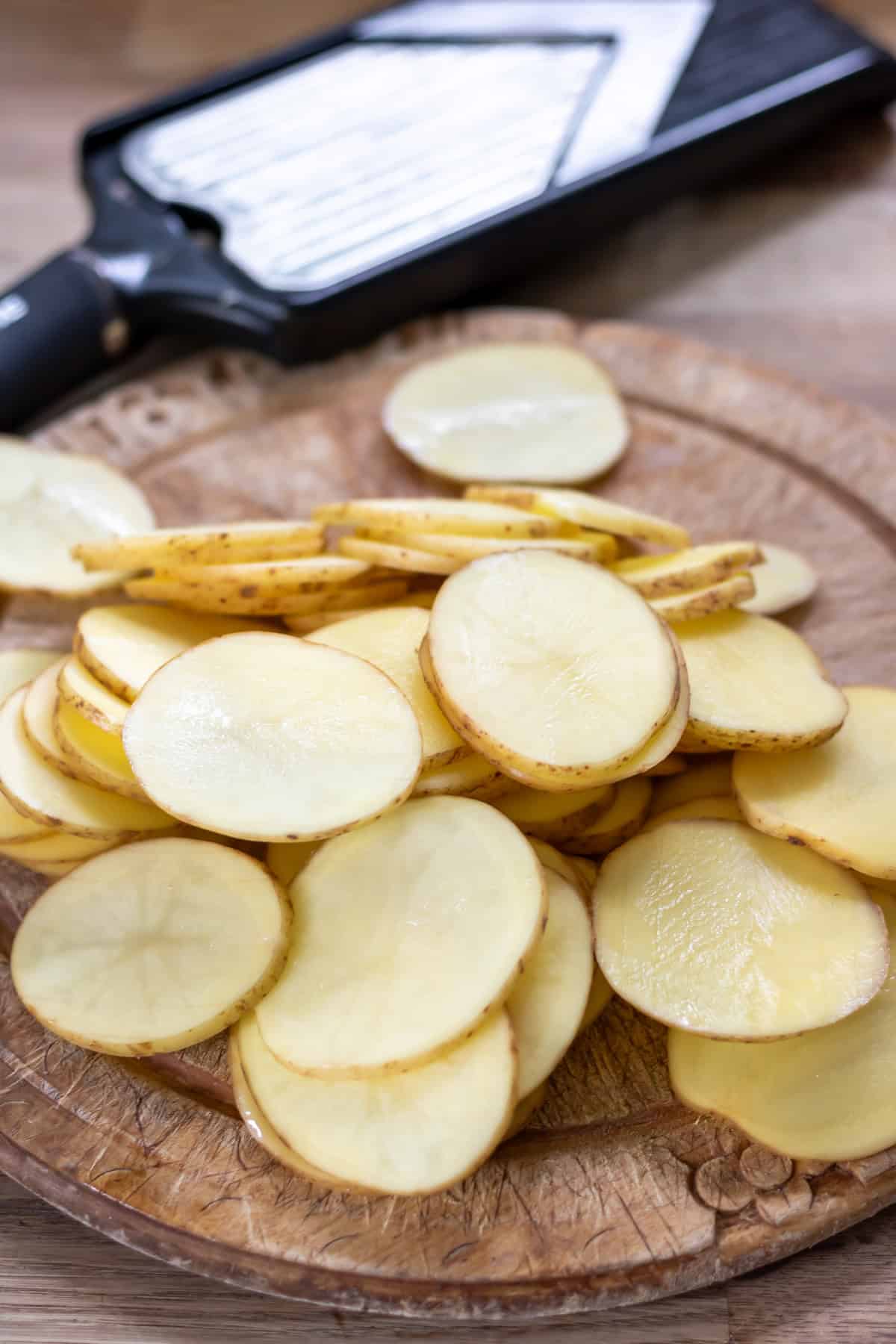 Slicing potatoes on a mandolin.