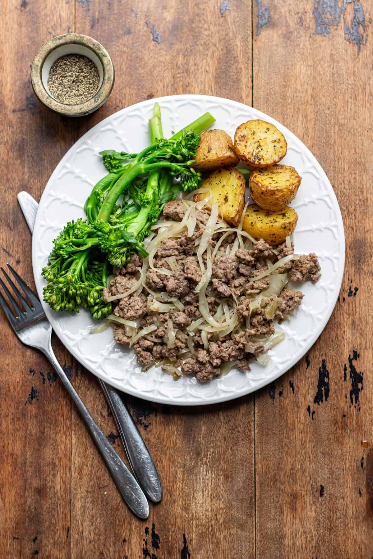 A plate of veggies and ground beef and cabbage.