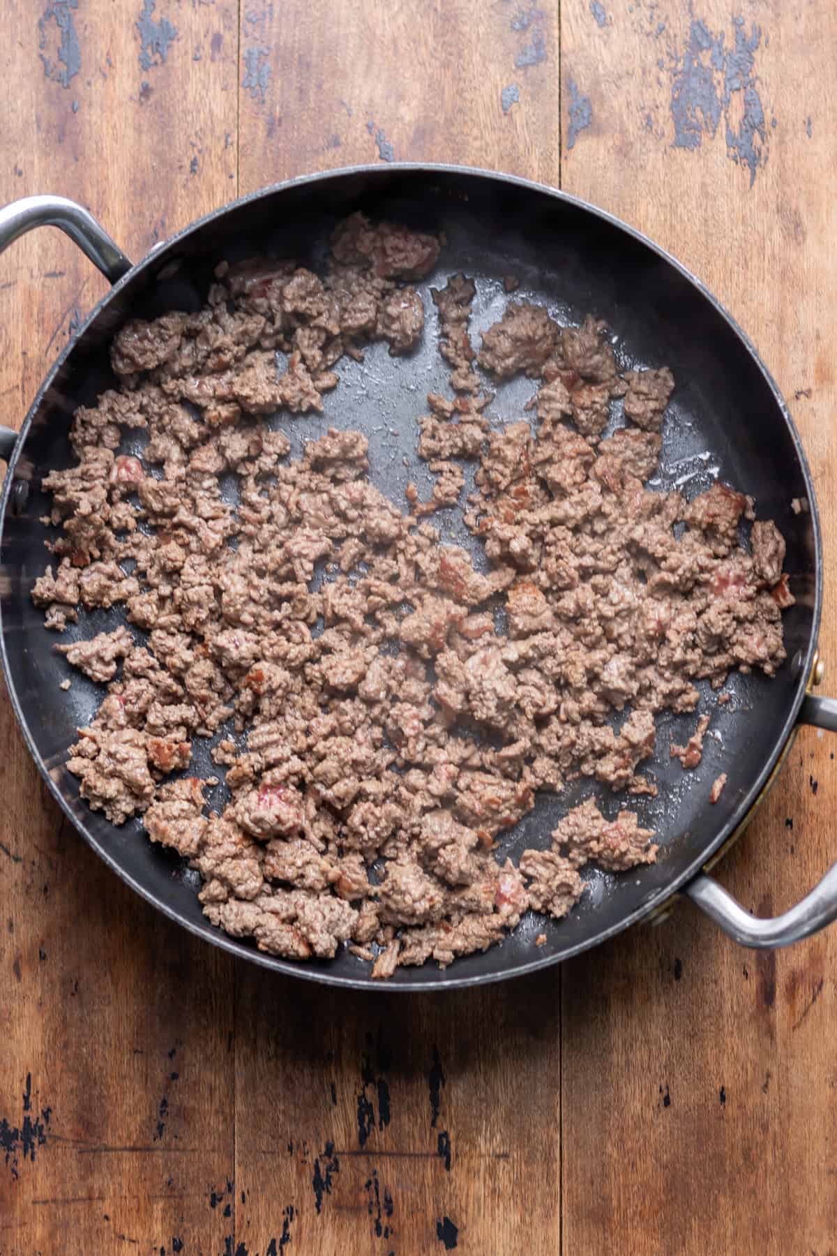 Ground beef browned in a skillet.