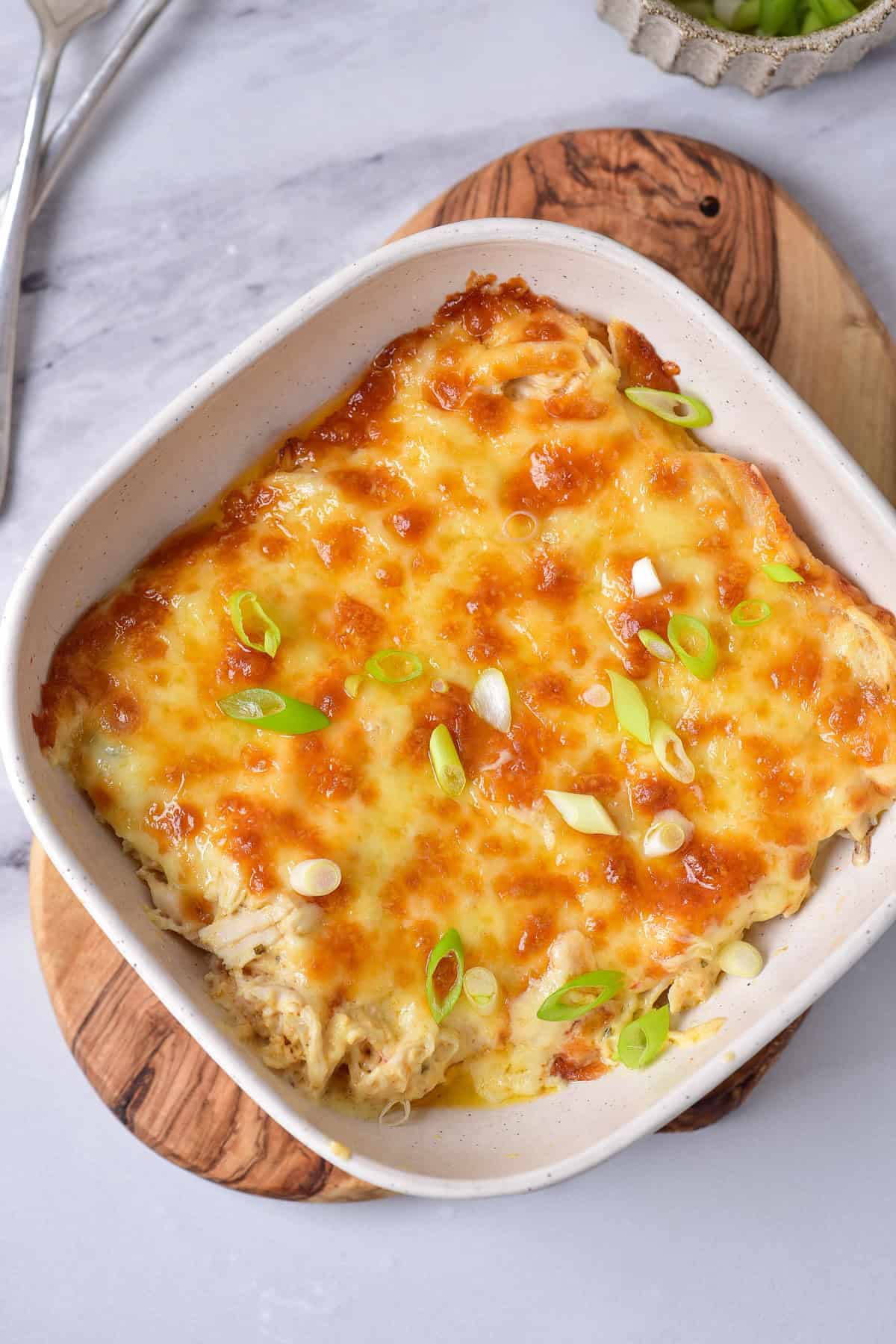 Scallions sprinkled onto the baked Buffalo ranch chicken dip.