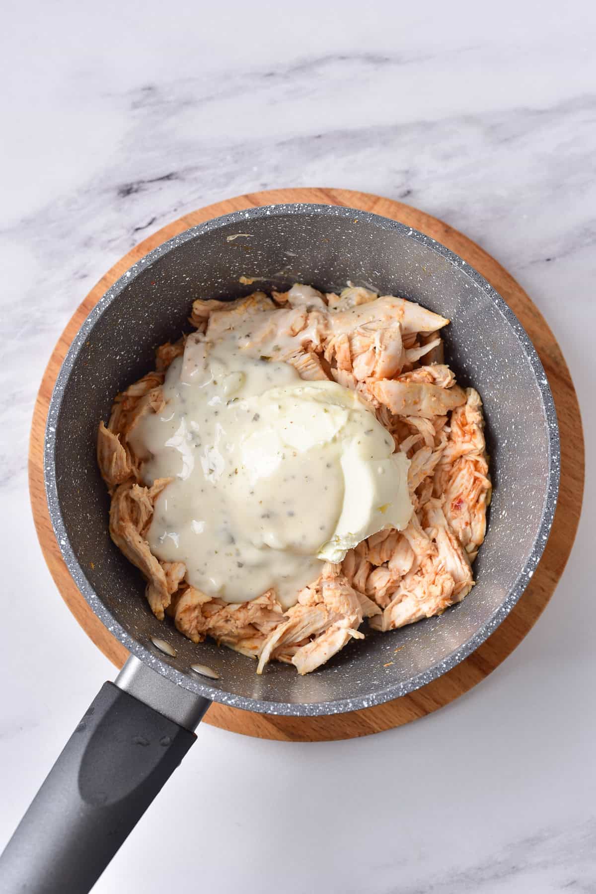 Ranch dressing added to the chicken and hot sauce.