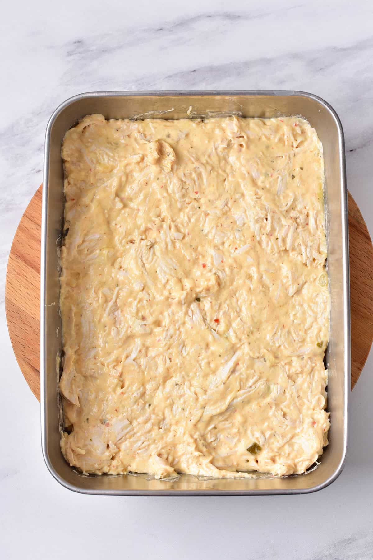 Buffalo ranch chicken mixture in a baking dish.