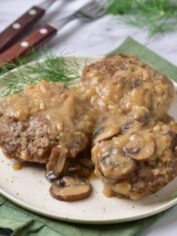 A plate of salisbury steaks with mushroom gravy.