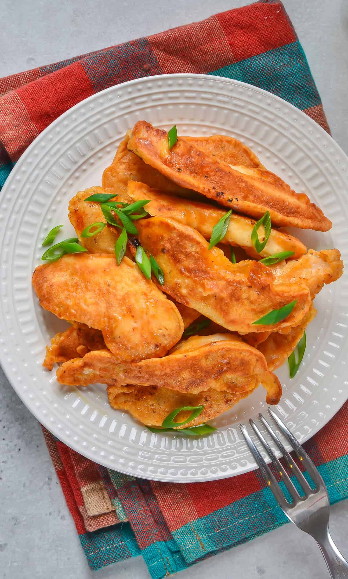 A plate of battered chicken tenders.