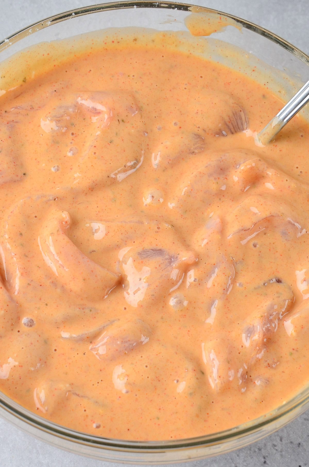 Chicken in the batter in a bowl.