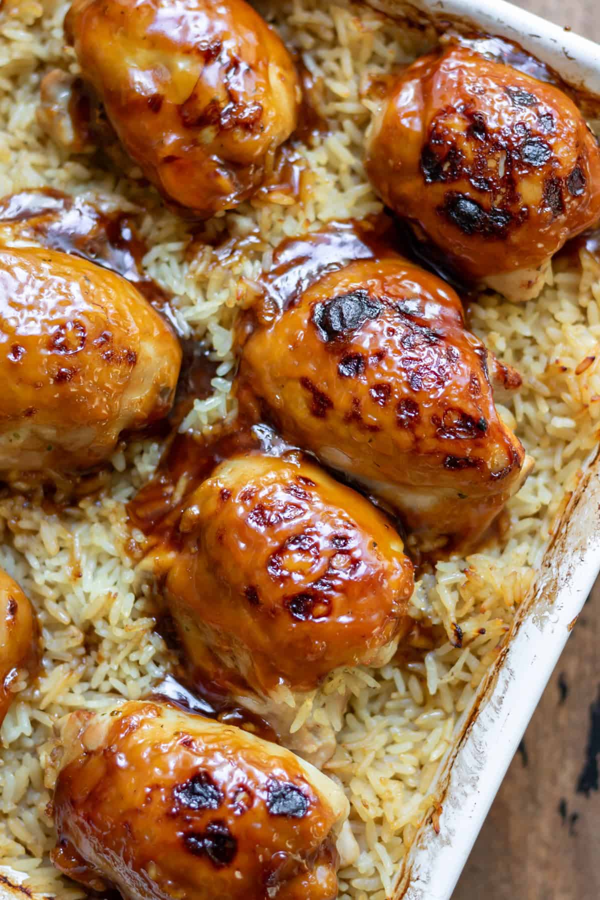 Close up of cooked sticky honey soy chicken thigh rice bake.