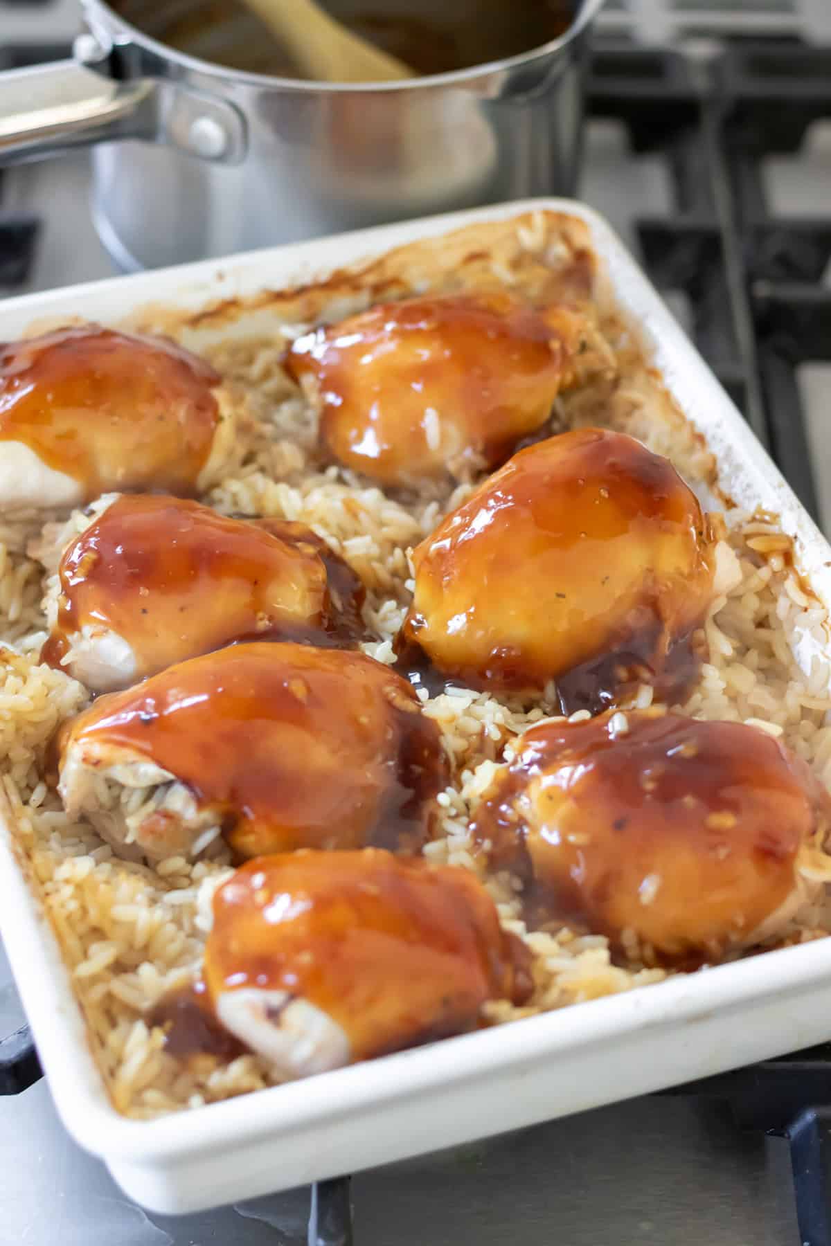 Sticky honey soy sauce poured onto the cooked chicken thighs in the rice bake.