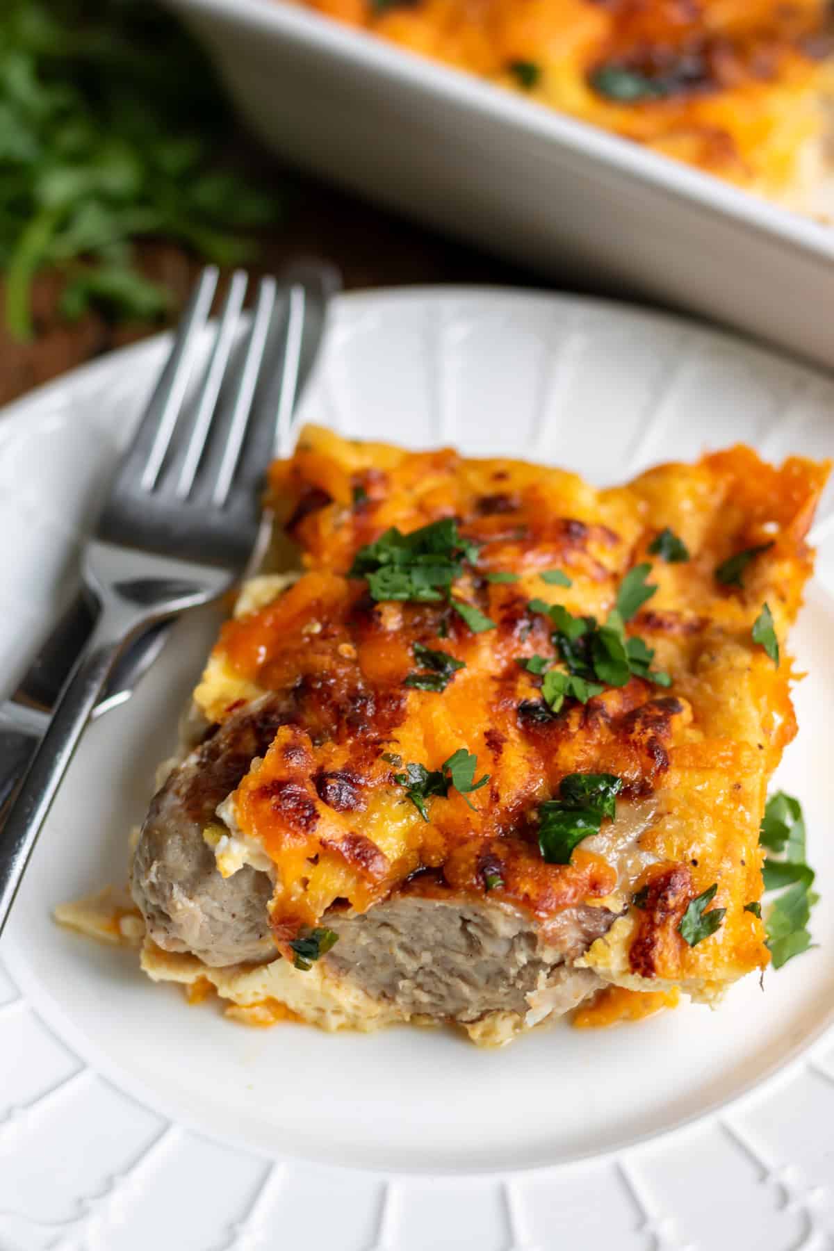 Close up of a slice of hot honey sausage breakfast bake on a plate.