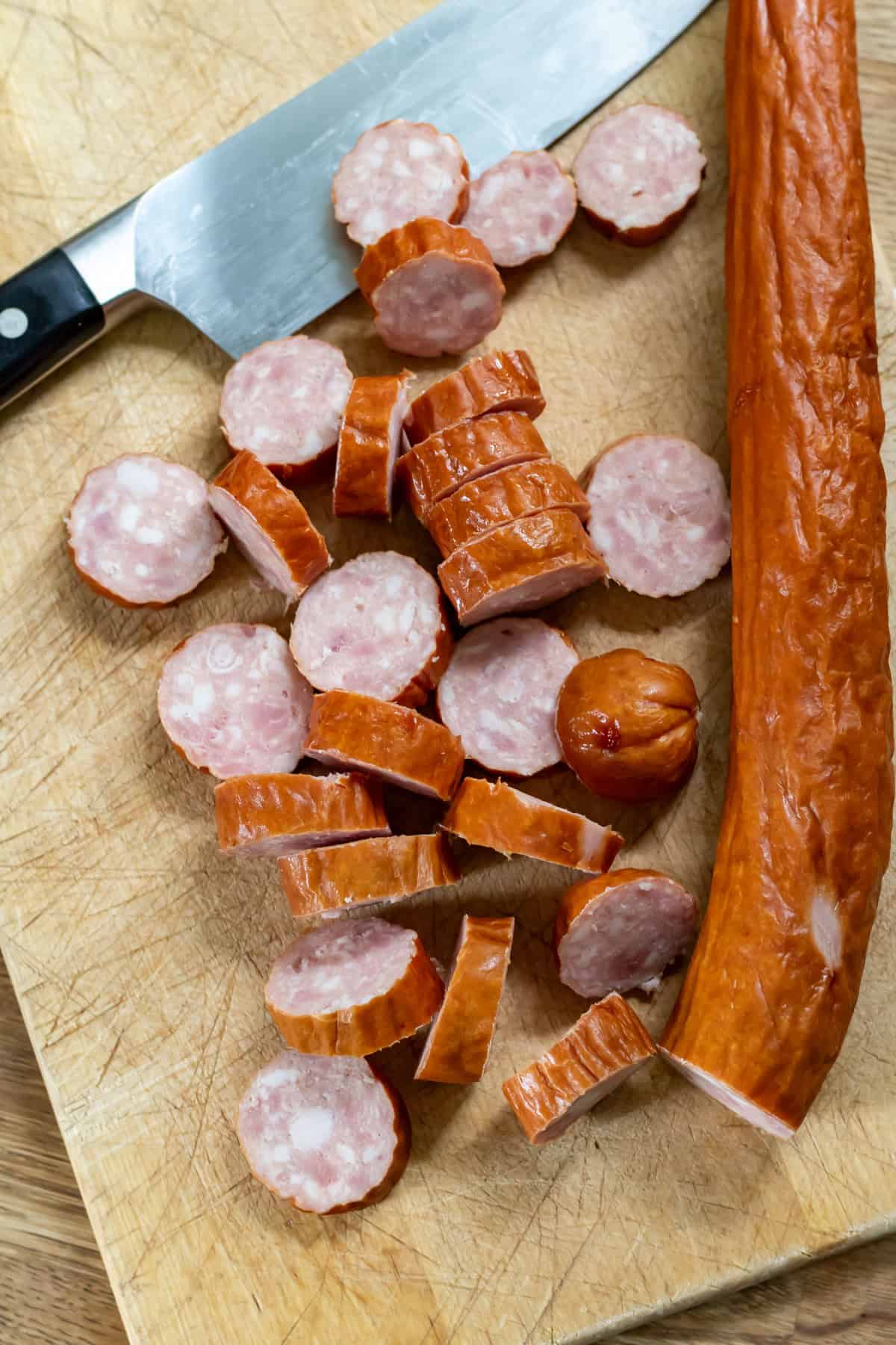 Slicing a smoked sausage.