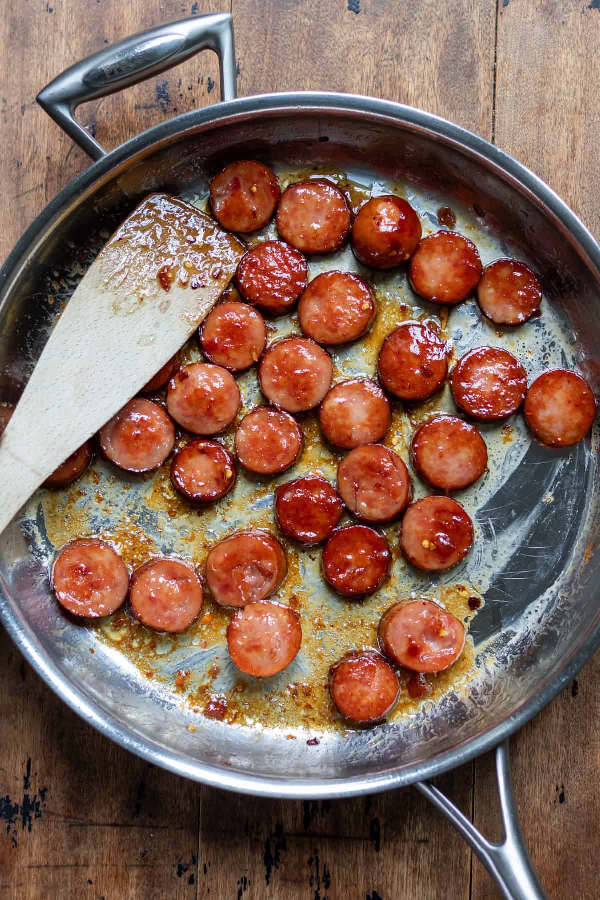 A pan of smoked sausage covered in hot honey.