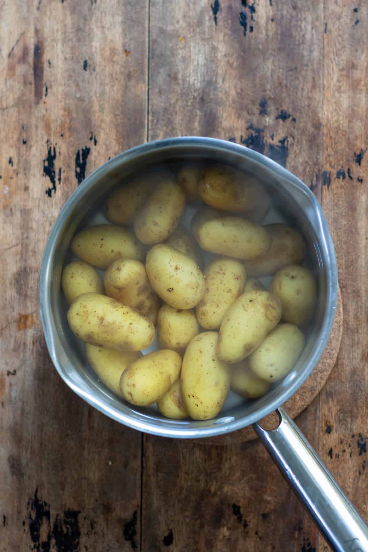 Boiling baby potatoes.